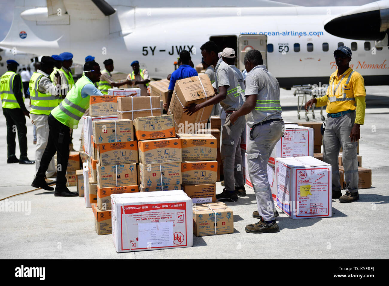 Somali police officers offload medical supplies donation from Kenyan