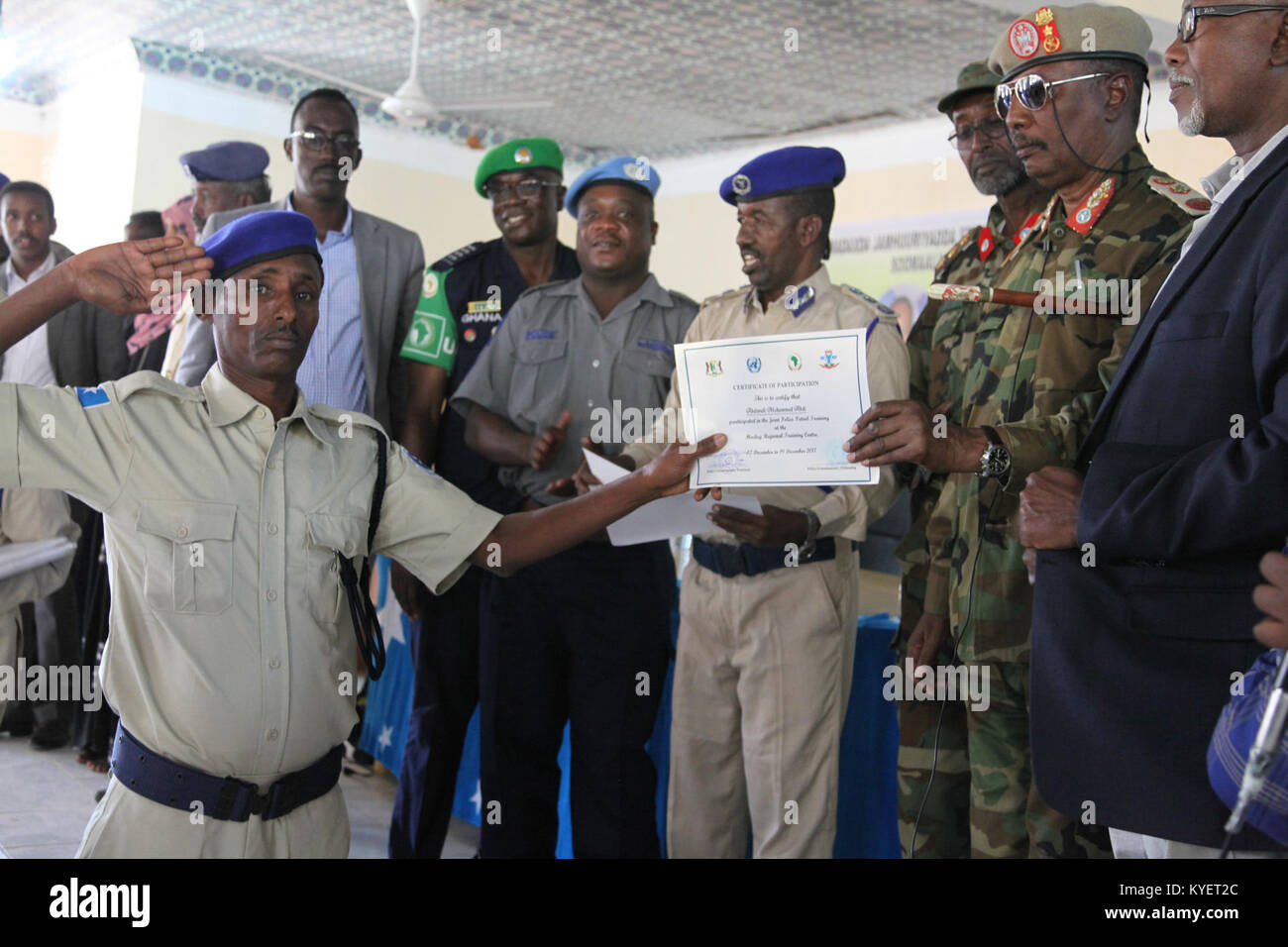 General Sa'ed Hersi, Puntland Army Commander hands over a certificate to a   police officer at the end of a Joint Police Patrol Training conducted by AMISOM and UN officers in Gaalkacyo, Somalia on December 19, 2017. AMISOM Photo Stock Photo