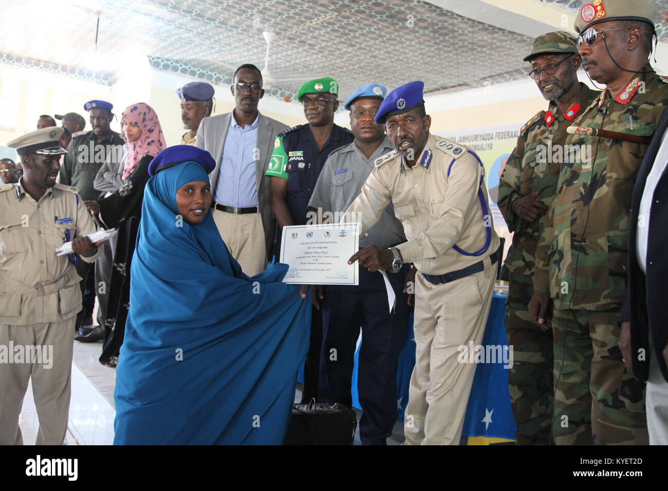 General Said Dheere, Puntland Police Commissioner   hands over a certificate to a female police officer at the end of a Joint Police Patrol Training conducted by AMISOM and UN officers in Gaalkacyo, Somalia on December 19, 2017. AMISOM Photo Stock Photo
