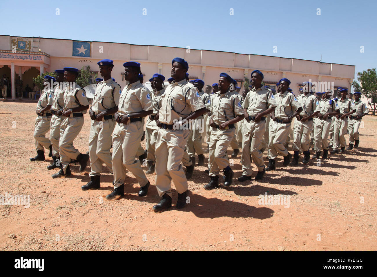 Police officers from Puntland and Galmudug State march at a parade mounted during the closing ceremony of a Joint Police Patrol Training conducted by AMISOM and UN officers in Gaalkacyo, Somalia on December 19, 2017. AMISOM Photo Stock Photo