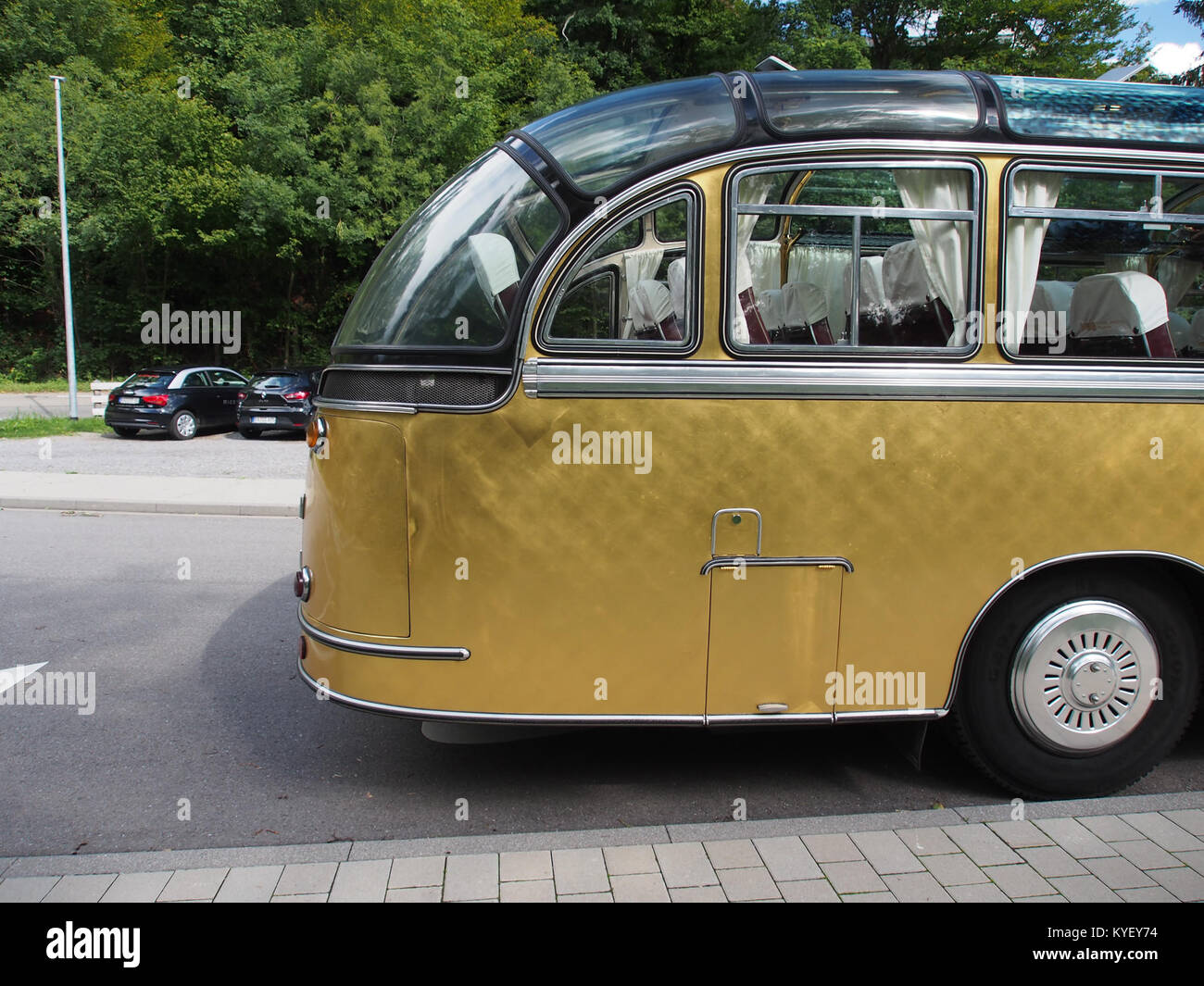 A photograph of a Neoplan bus at Schmuckwelten in Pforzheim, Germany. The image highlights the design and structure of the bus in a unique setting related to the display of art and culture. Stock Photo