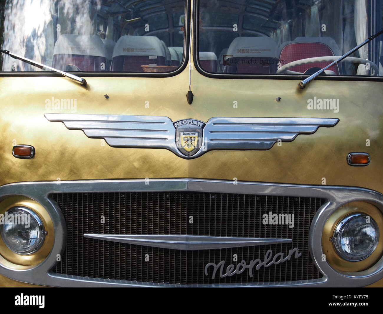 A photograph of a Neoplan bus parked at Schmuckwelten Pforzheim, a jewelry museum in Germany, showcasing the modern vehicle against a historic backdrop. Stock Photo