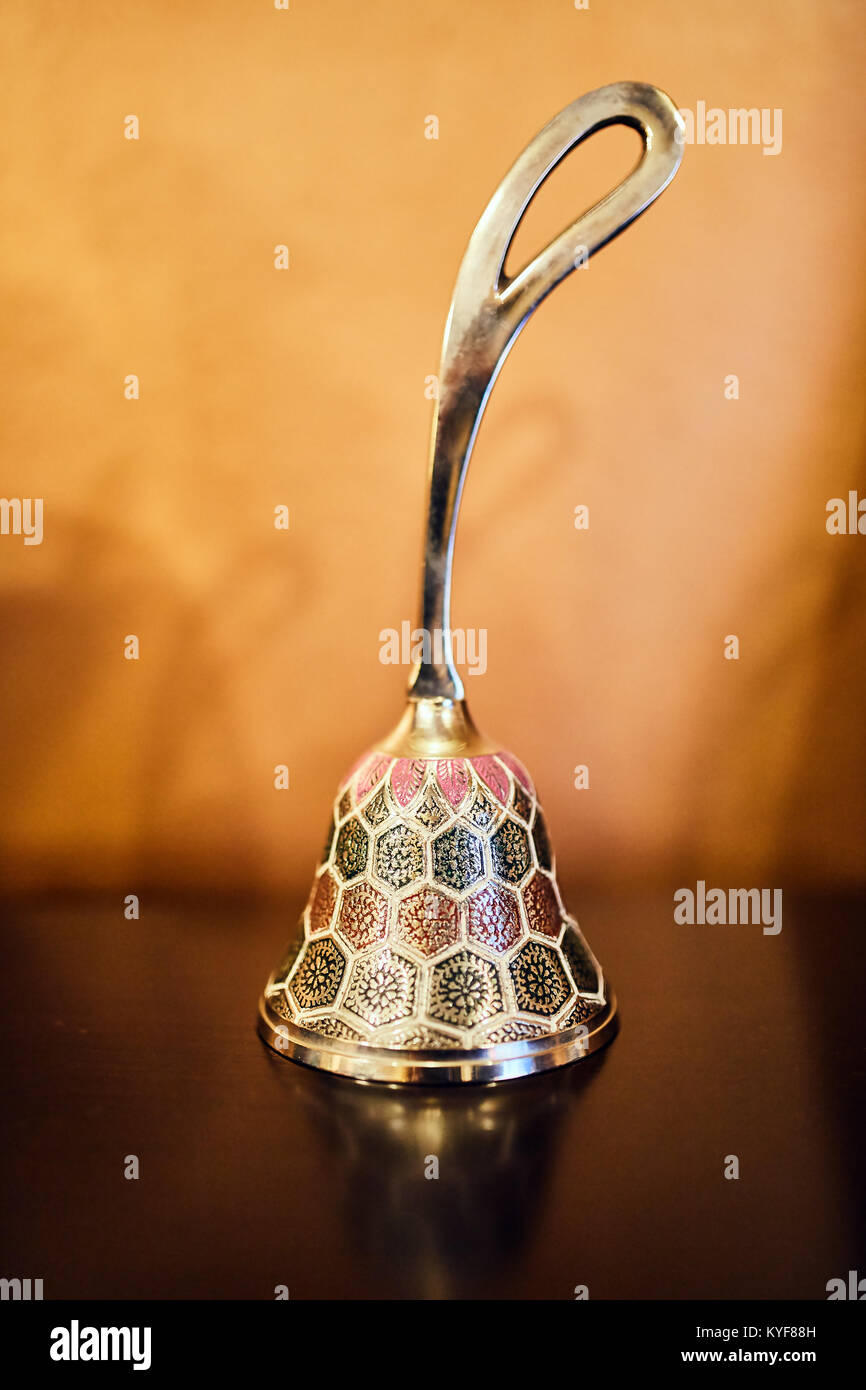 Closeup of a colorful silver bell on a table Stock Photo - Alamy