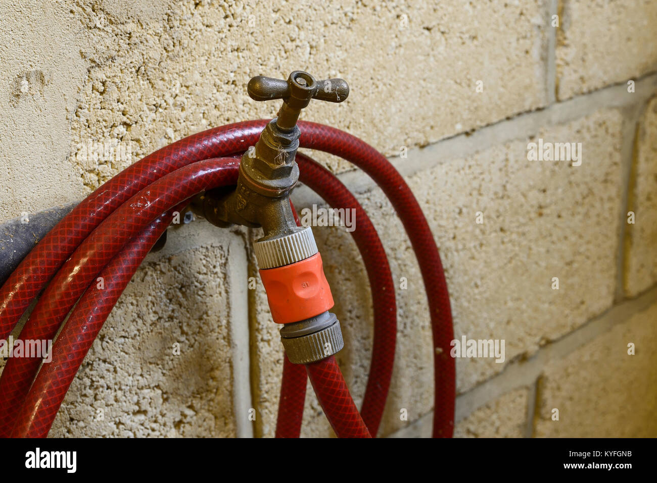 Garden tap and hosepipe inside a garage Stock Photo