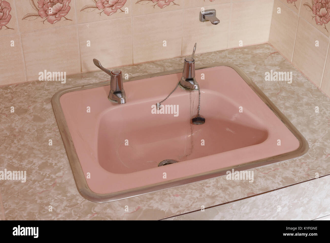 Domestic vanity unit hand basin in coral pink ceramic Stock Photo
