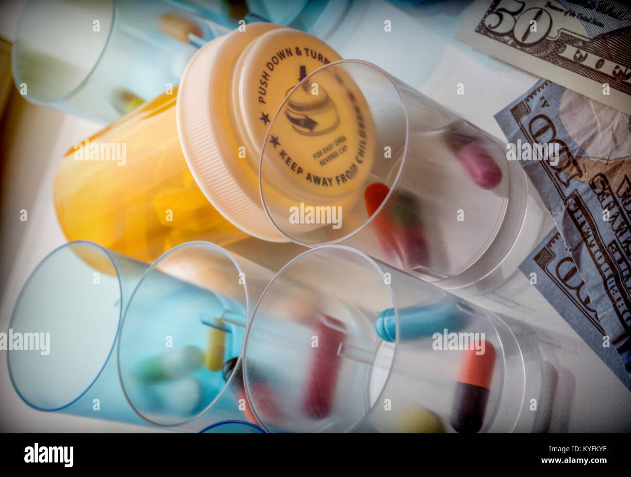 Some medicines next to a block of tickets of dollar, conceptual image Stock Photo