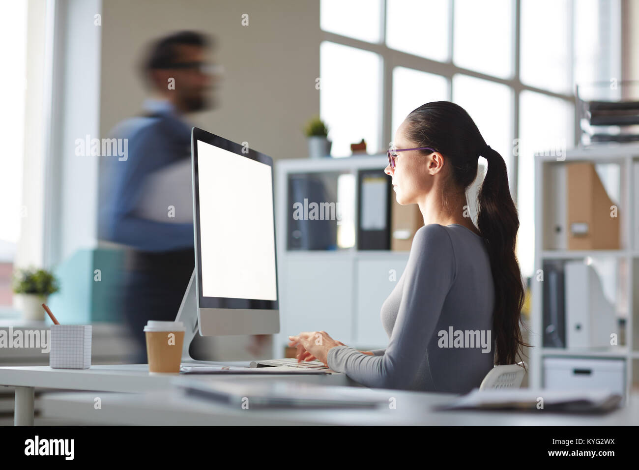 Working by computer Stock Photo - Alamy