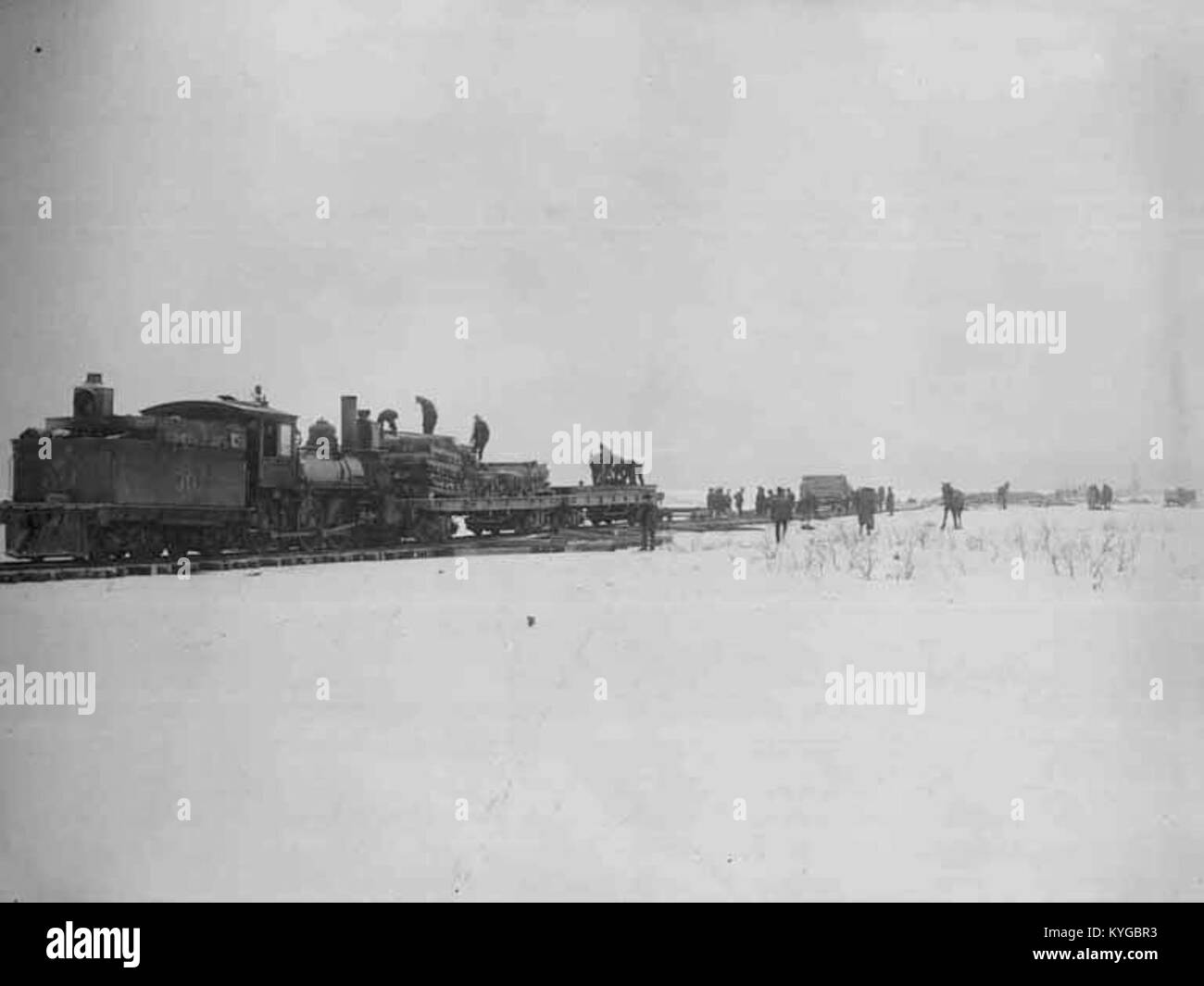Railroad construction crew laying railroad track at Mile 20, vicinity