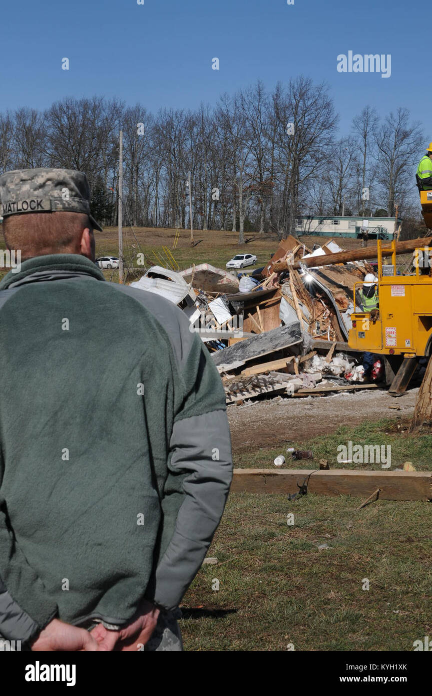 Staff Sgt. Joshua Matlock, with the Charlie Battery, 1st Battalion, 623rd Field Artillery (HIMARS), views the debris that covered the area of East Bernstadt Ky. Mar. 3. (Photo by Spc. Brandy Mort, 133rd Mobile Public Affairs Detachment, Kentucky National Guard) Stock Photo