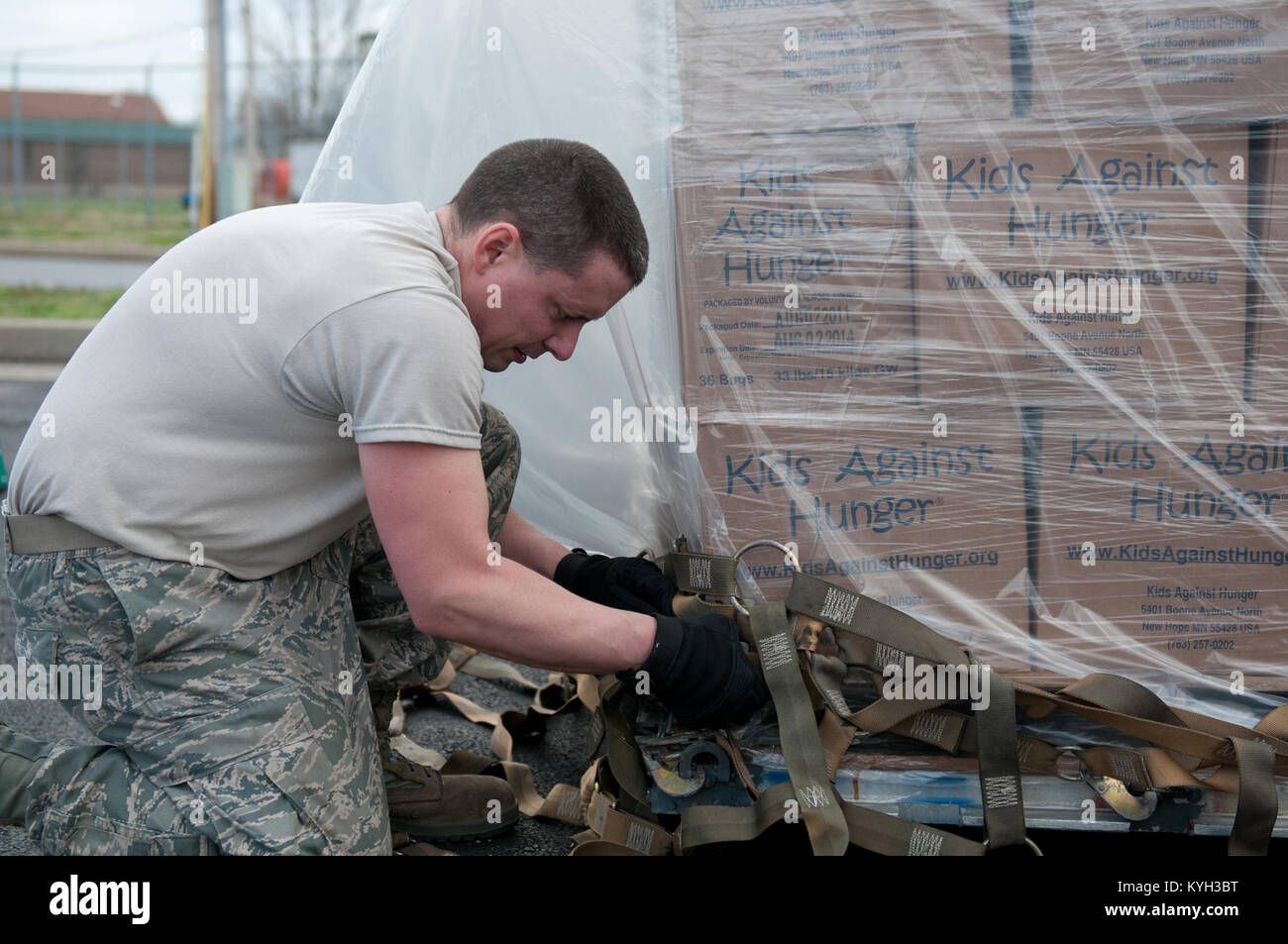 Staff Sgt. Raymond Graves III, an air cargo specialist with the 123rd Logistics Readiness Squadron, secures cargo netting on a pallet of humanitarian goods bound for Haiti on March 13, 2012. The Kentucky Air National Guard is helping Children’s Lifeline, a Kentucky-based non-profit organization, ship food and other supplies to Haiti through the Denton Program. The Denton Program is a U.S. government effort that allows private citizens and organizations to use space available on U.S. military cargo planes to transport humanitarian goods. (U.S. Air Force photo by Master Sgt. Phil Speck) Stock Photo
