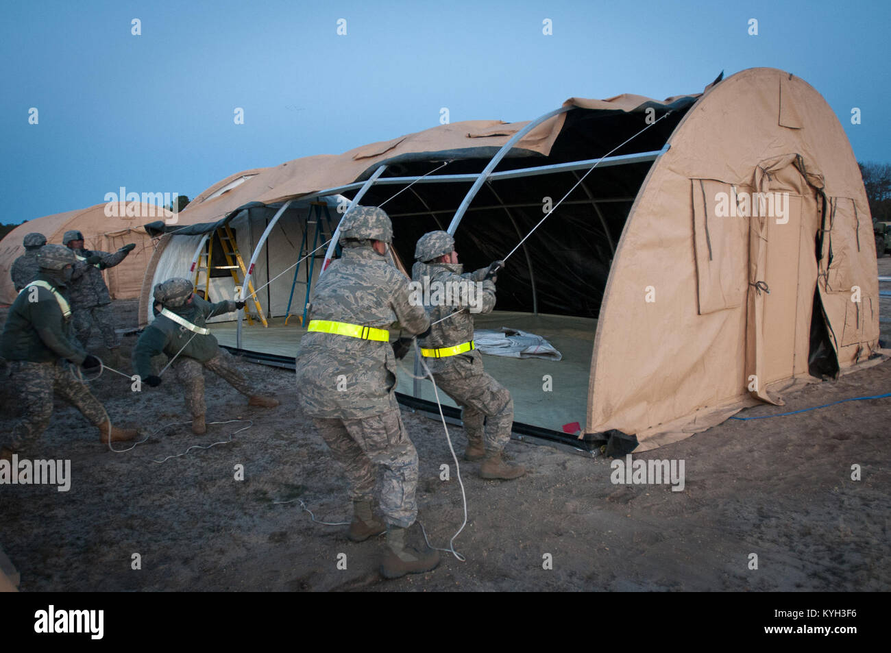 Airmen from the Kentucky Air National Guard’s 123rd Contingency Response Group set up an Alaskan Shelter tent at Joint Base McGuire-Dix-Lakehurst, N.J., March 26, 2012, during Exercise Eagle Flag. More than 80 Airmen from the Kentucky Air Guard have joined forces with over 50 active-duty Army troops and Air Guardsmen from New Jersey and Mississippi to establish an aerial port at Lakehurst Naval Air Engineering Station within 24 hours of arrival. Inspectors from U.S. Transportation Command will evaluate the performance of the Kentucky unit during the exercise. (U.S. Air Force photo by Maj. Dale Stock Photo