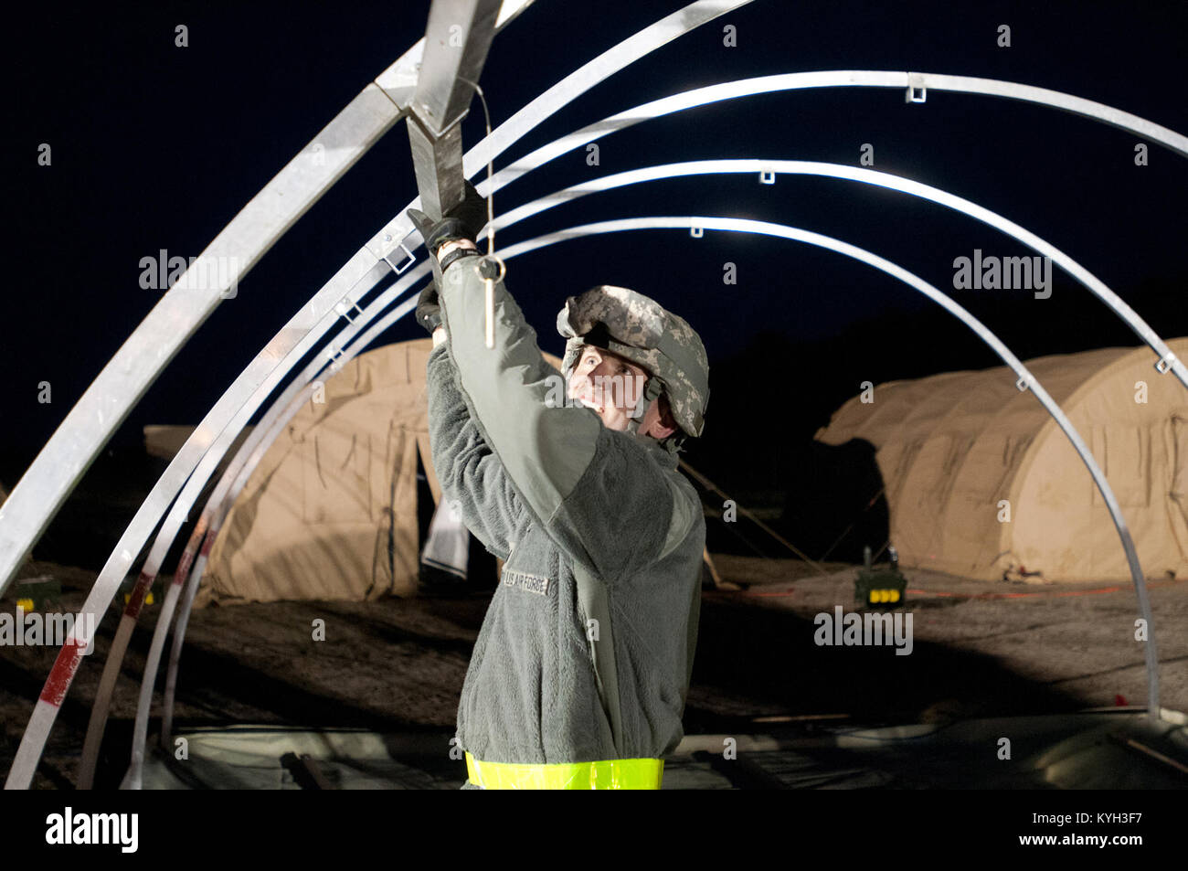 1st Lt. Kevin Eilers of the Kentucky Air National Guard’s 123rd Contingency Response Group sets up an Alaskan Shelter tent at Joint Base McGuire-Dix-Lakehurst, N.J., March 26, 2012, during Exercise Eagle Flag. More than 80 Airmen from the Kentucky Air Guard have joined forces with over 50 active-duty Army troops and Air Guardsmen from New Jersey and Mississippi to establish an aerial port at Lakehurst Naval Air Engineering Station within 24 hours of arrival. Inspectors from U.S. Transportation Command will evaluate the performance of the Kentucky unit during the exercise. (U.S. Air Force photo Stock Photo