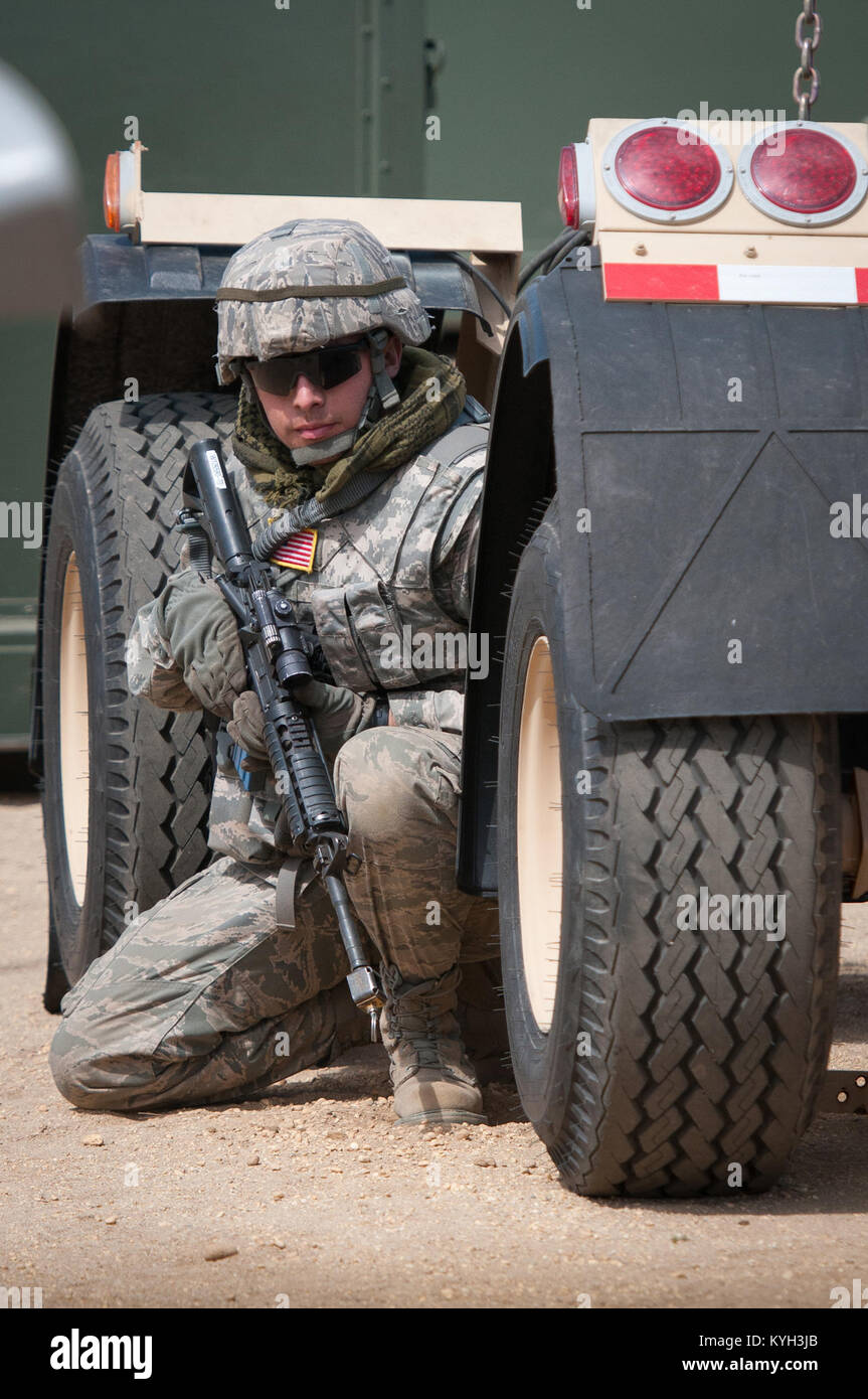 Senior Airman Beau DeLeon, a civil engineer from the New Jersey Air Guard’s 108th Contingency Response Group, takes cover during a simulated enemy attack at Joint Base McGuire-Dix-Lakehurst, N.J., on March 29, 2012. DeLeon was participating in an exercise called Eagle Flag, along with more than 80 Airmen from the Kentucky Air National Guard’s 123rd Contingency Response Group and about 50 active-duty Soldiers from the U.S. Army’s 690th Rapid Port Opening Element. (U.S. Air Force photo by Maj. Dale Greer) Stock Photo