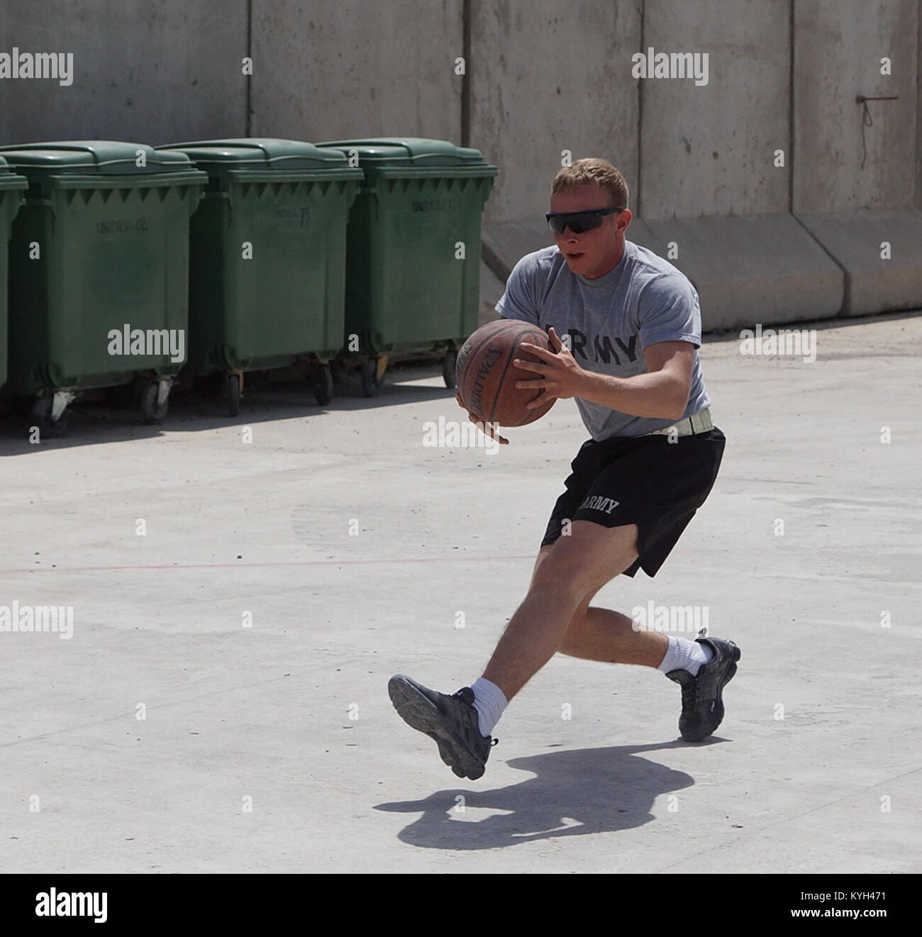 Spc. Jesse Loghry, a 22-year-old Irvington, Ky. resident on his third deployment in four years, chases down a basketball during team building exercises in Southern Afghanistan on April 23, 2012. Loghry, a combat medic by trade, serves as a vehicle gunner on Kentucky’s Agribusiness Development Team 4. (Photo by U.S. Army Staff Sgt. Paul Evans) Stock Photo