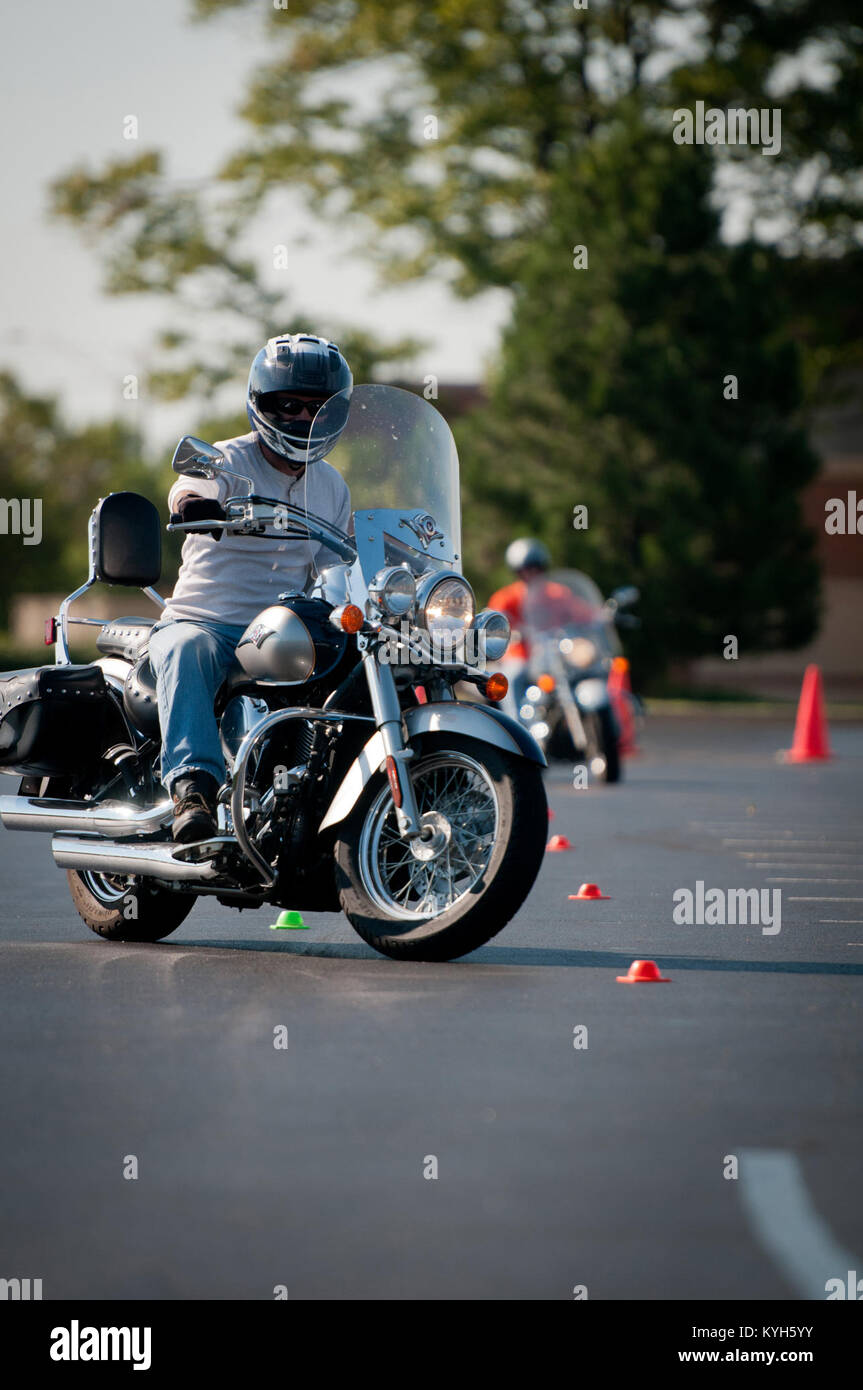 Kentucky Air National Guard Lt. Col. Armand Bolotte, 123rd Logistics  Readiness Squadron operations officer, weaves in out of cones during a motorcycle  safety train-the-trainer course at the Kentucky Air National Guard Base