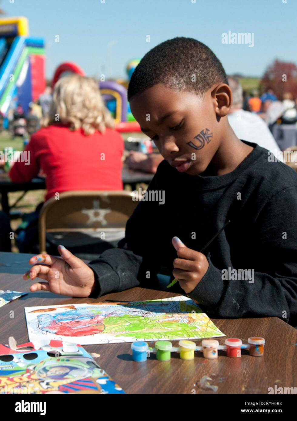 Adarius Hite, son of Kentucky Air National Guard member 2nd Lt. Angela Hite, paints pictures during Family Day at the 123rd Airlift Wing in Louisville, Ky., Oct. 21, 2012.  (Kentucky Air National Guard photo by Senior Airman Vicky Spesard) Stock Photo