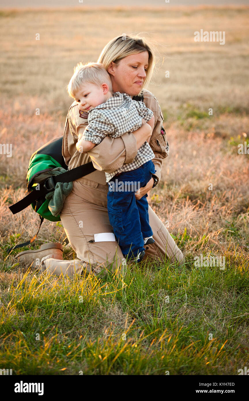 Maj. Jennifer Helton, a navigator for the 165th Airlift Squadron, fights back tears Nov. 10, 2012, as she hugs her son, Kaiden Helton, next to the flight line of the Kentucky Air National Guard Base in Louisville, Ky. Helton was one of 58 Kentucky Air Guardsmen returning from a four-month deployment to the Persian Gulf region. (U.S. Air Force photo by Maj. Dale Greer) Stock Photo