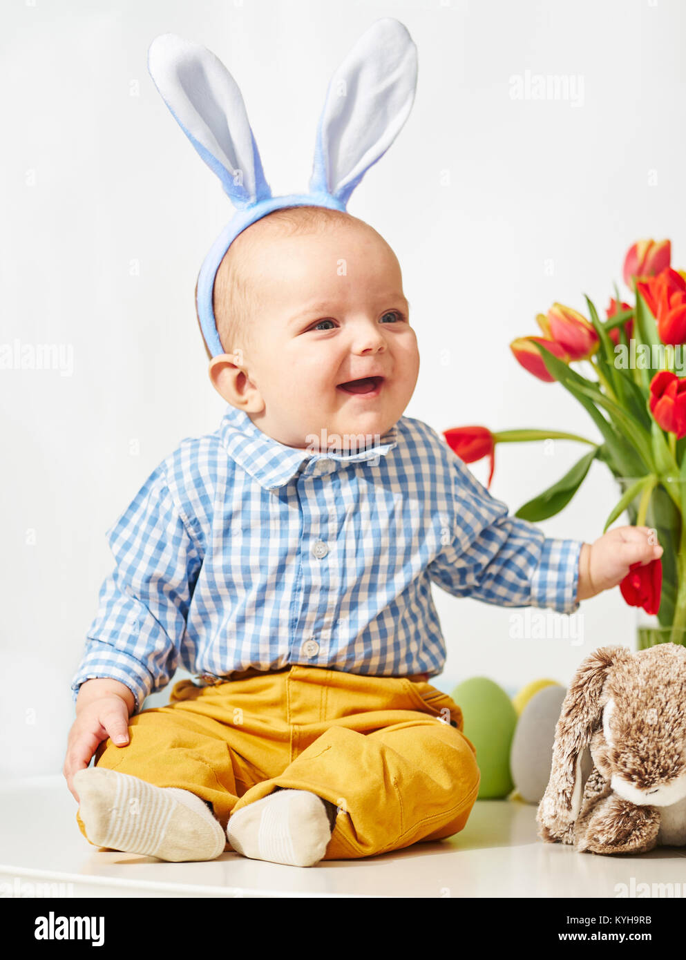 Happy baby boy with bunnies ears Stock Photo
