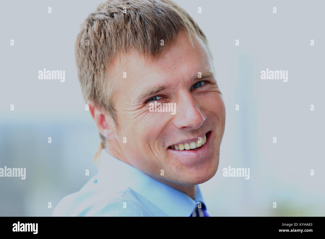 Portrait of smiling young businessman at office Stock Photo - Alamy
