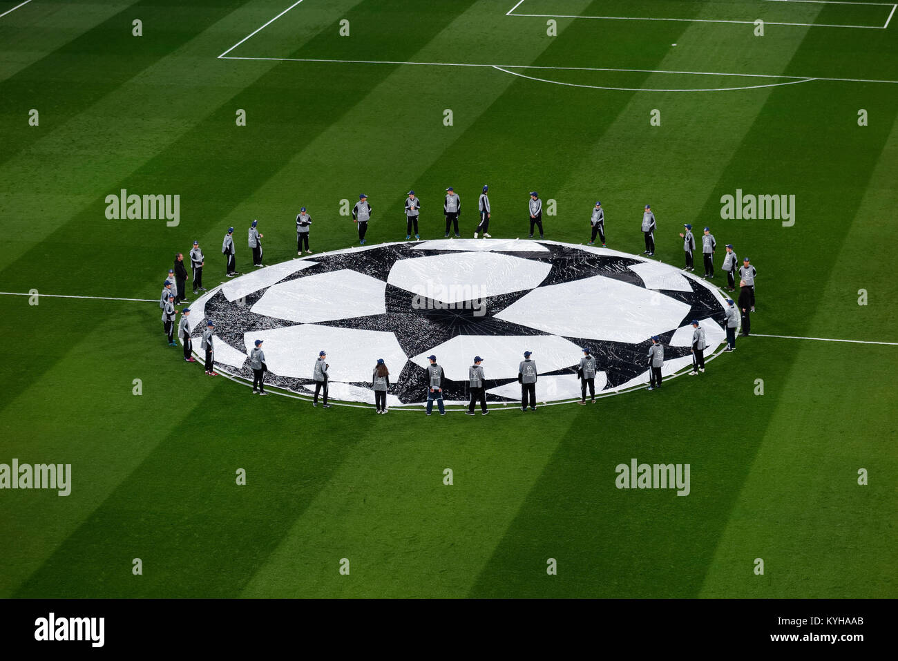 MADRID, SPAIN - FEBRUARY 17, 2017: top view of guys around Uefa Champions League logo on the grass of Santiago Bernabeu soccer stadium Stock Photo
