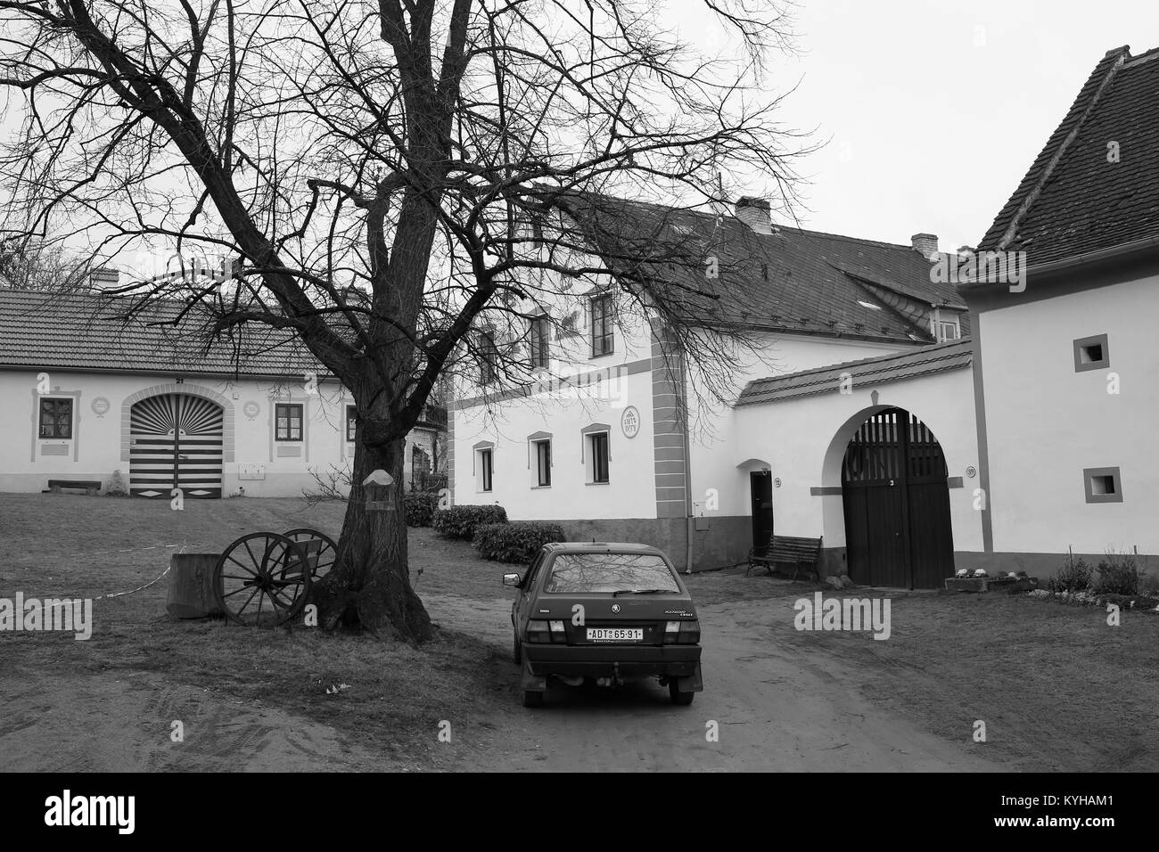 Old Skoda Favorit car in front of a house in the South Bohemian Folk or Rural Baroque style (18th and 19th-century) in Holasovice village Stock Photo
