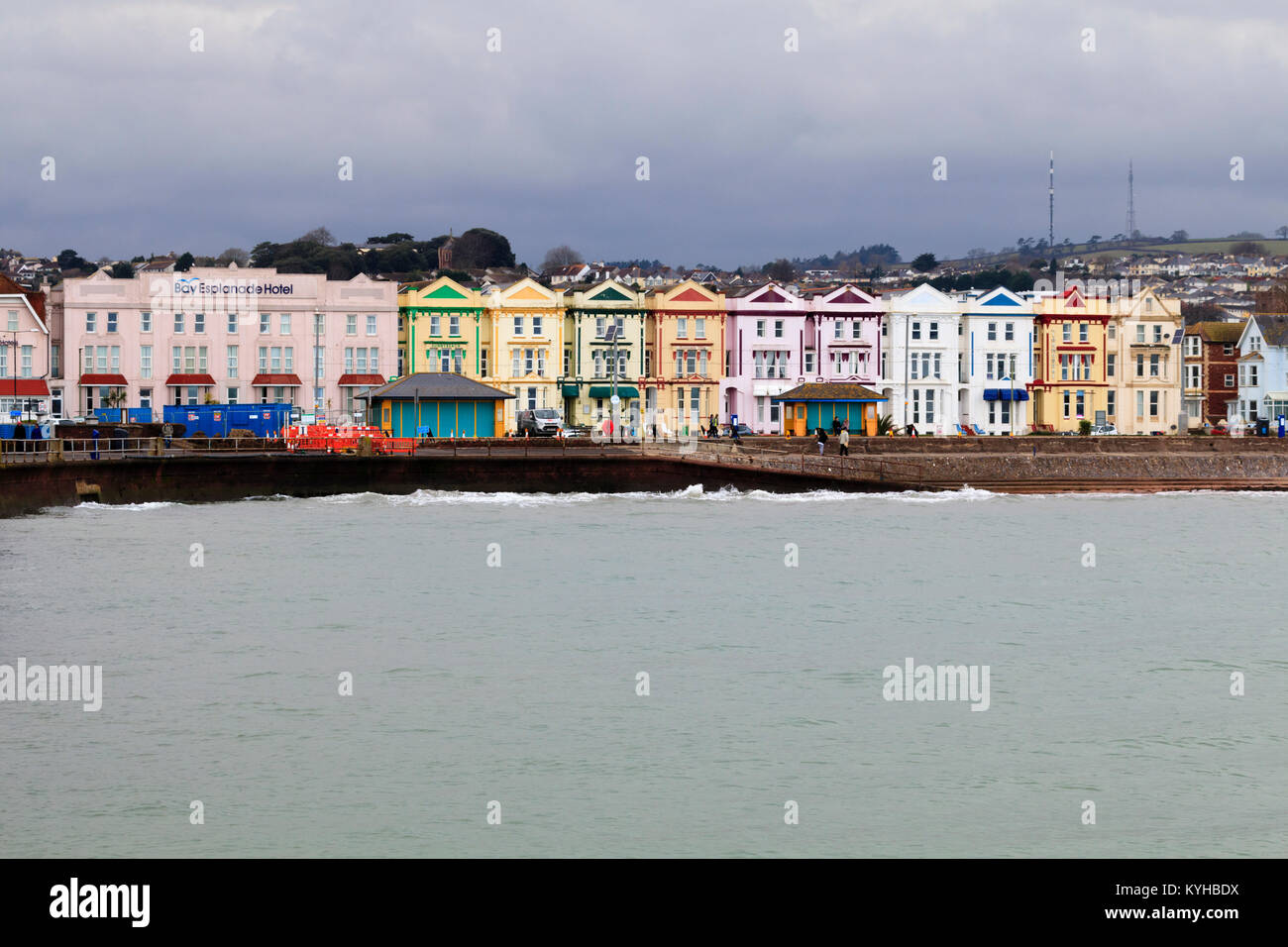 Colourful facades of Victorian buildings housing hotels brighten a grey January day on the Esplanade at Paignton, Devon, UK Stock Photo