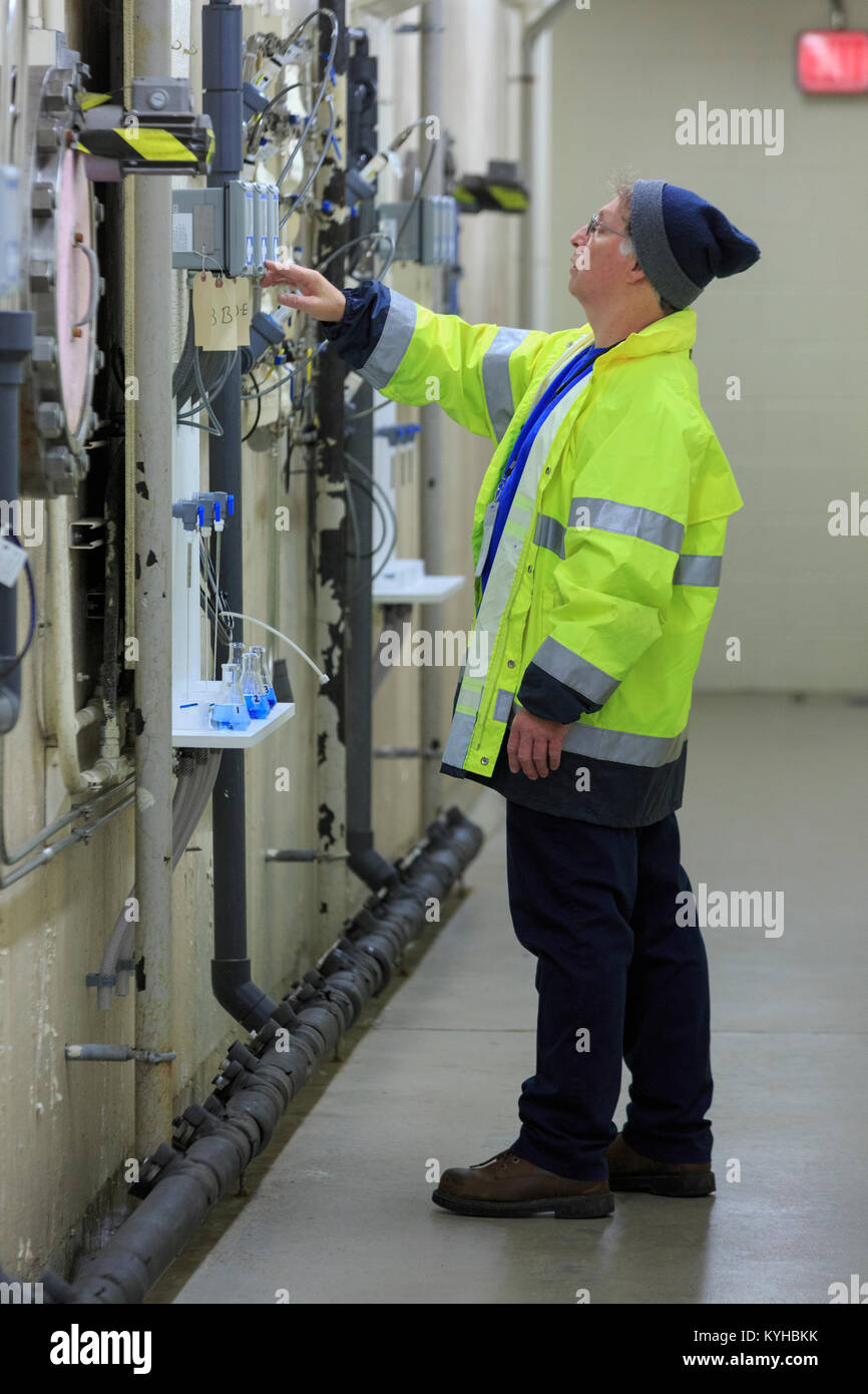 Water department engineer examining instrumentation panel Stock Photo