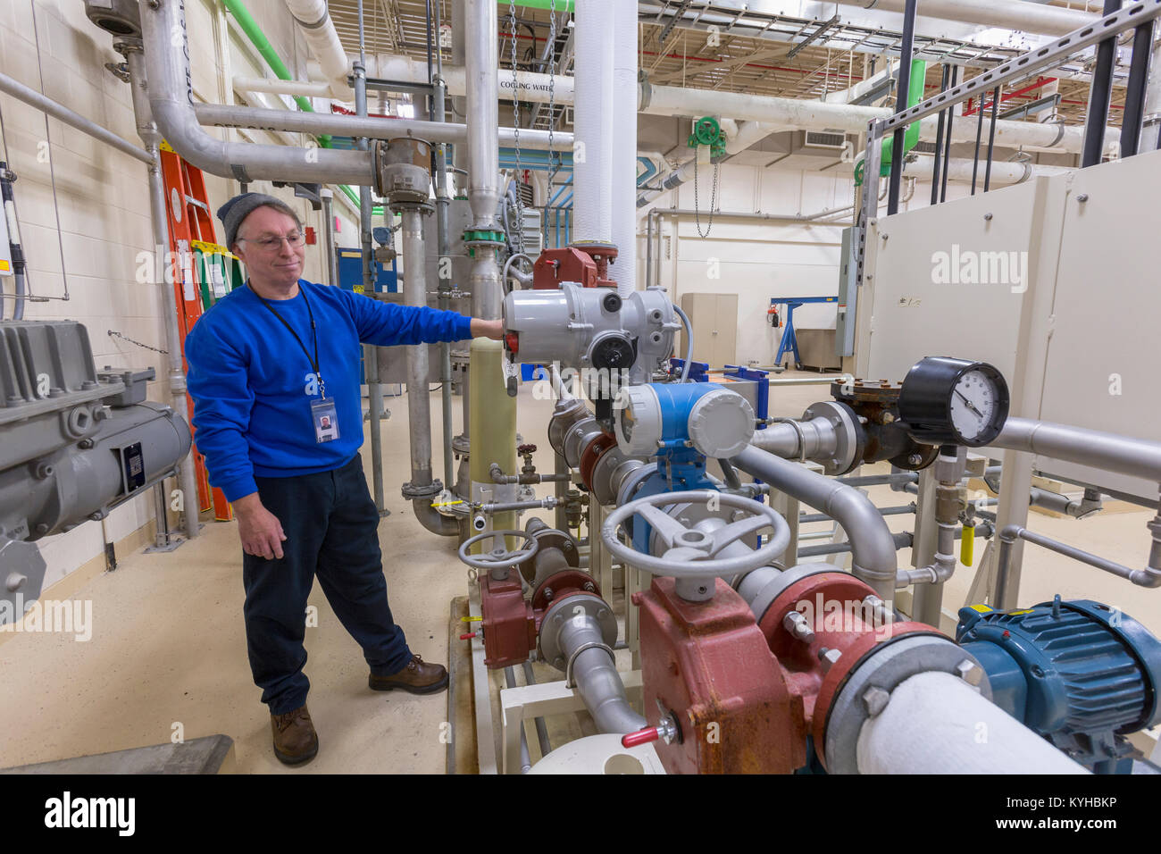 Water treatment plant engineer inspecting chemical treatment equipment Stock Photo