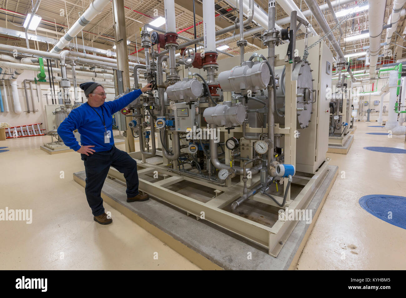 Water department engineer standing in chemical treatment room Stock
