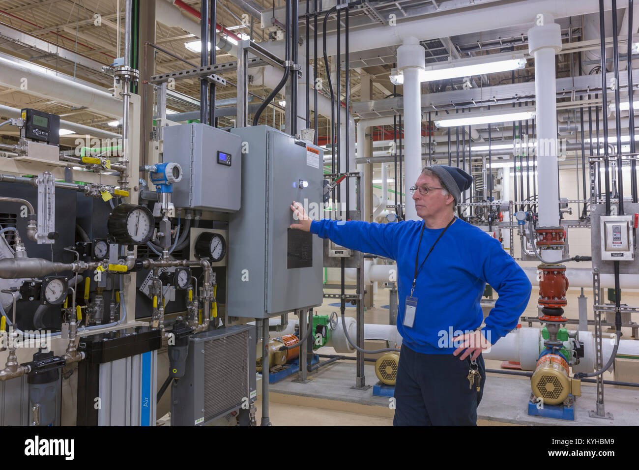 Water department engineer standing in chemical treatment room Stock Photo