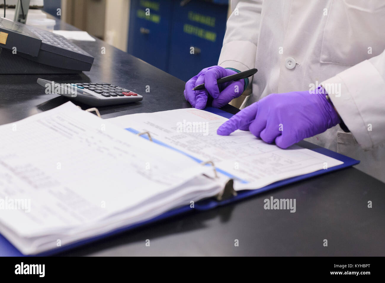 Lab technician recording data from sample test Stock Photo