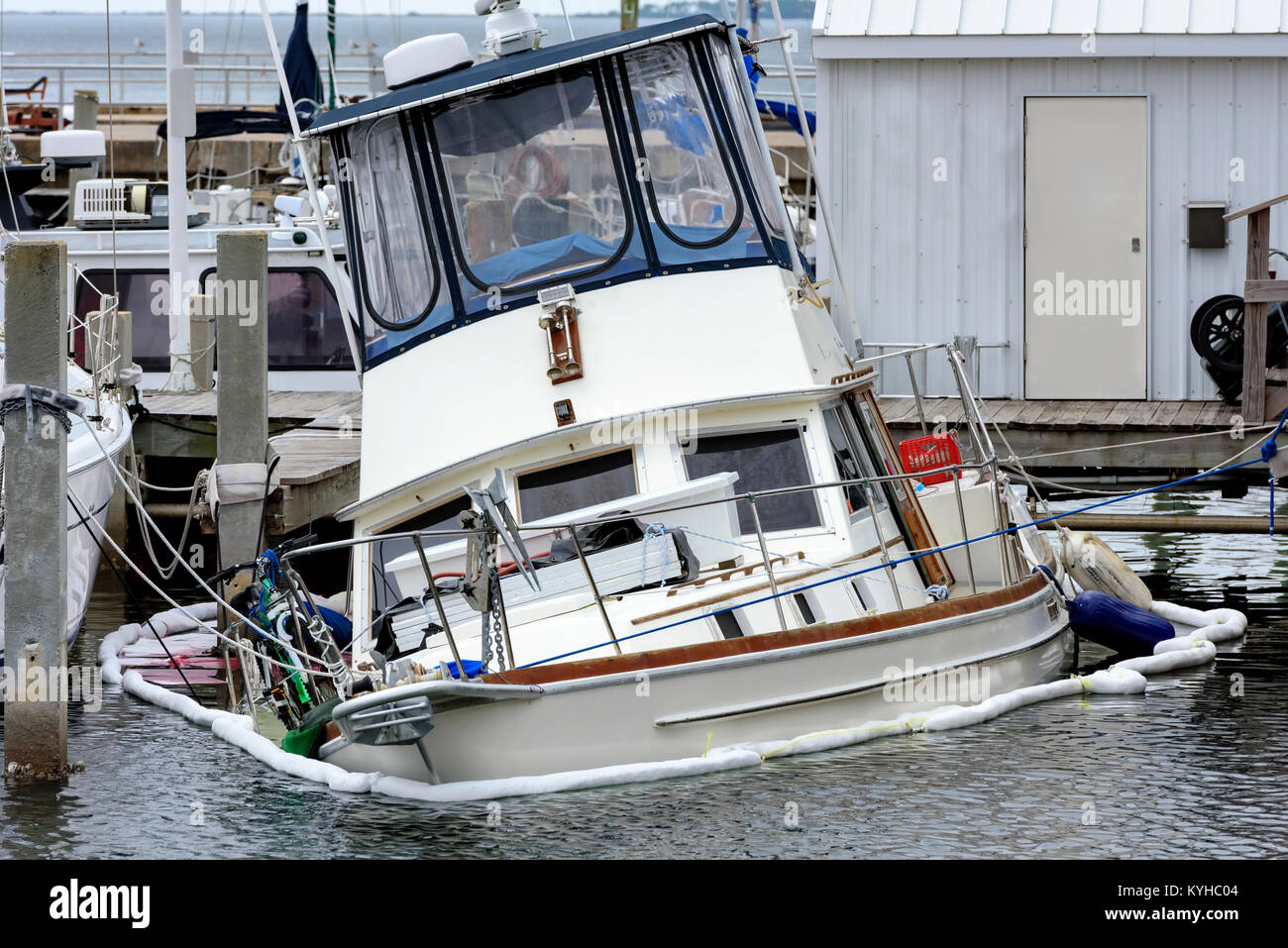 sinking pleasure boat at panama city marina. Looks as if the mooring ropes kept this boat from going under. Stock Photo