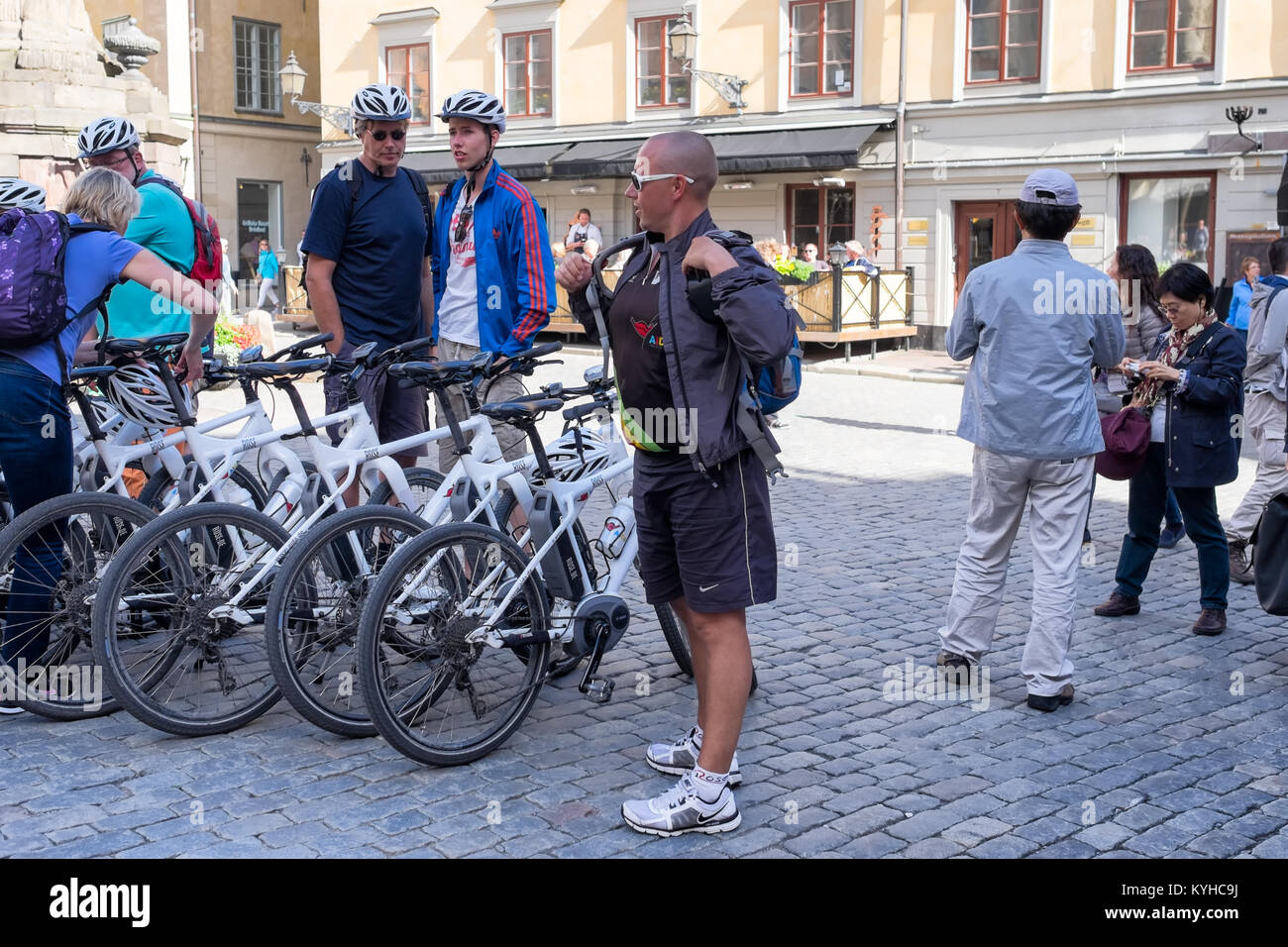 Stockholm Sweden bike tour group meets in a public square in Gamla Stan, the historic old town quarter in Stockholm. Bicycles are lined up Stock Photo