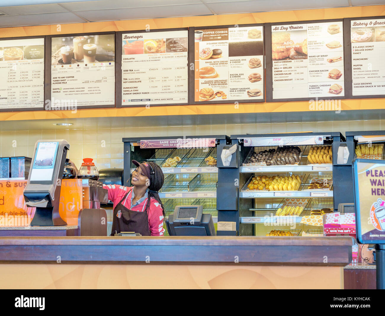 Female African-American fast food worker at the counter of Dunkin Donuts in Montgomery, Alabama United States. Stock Photo