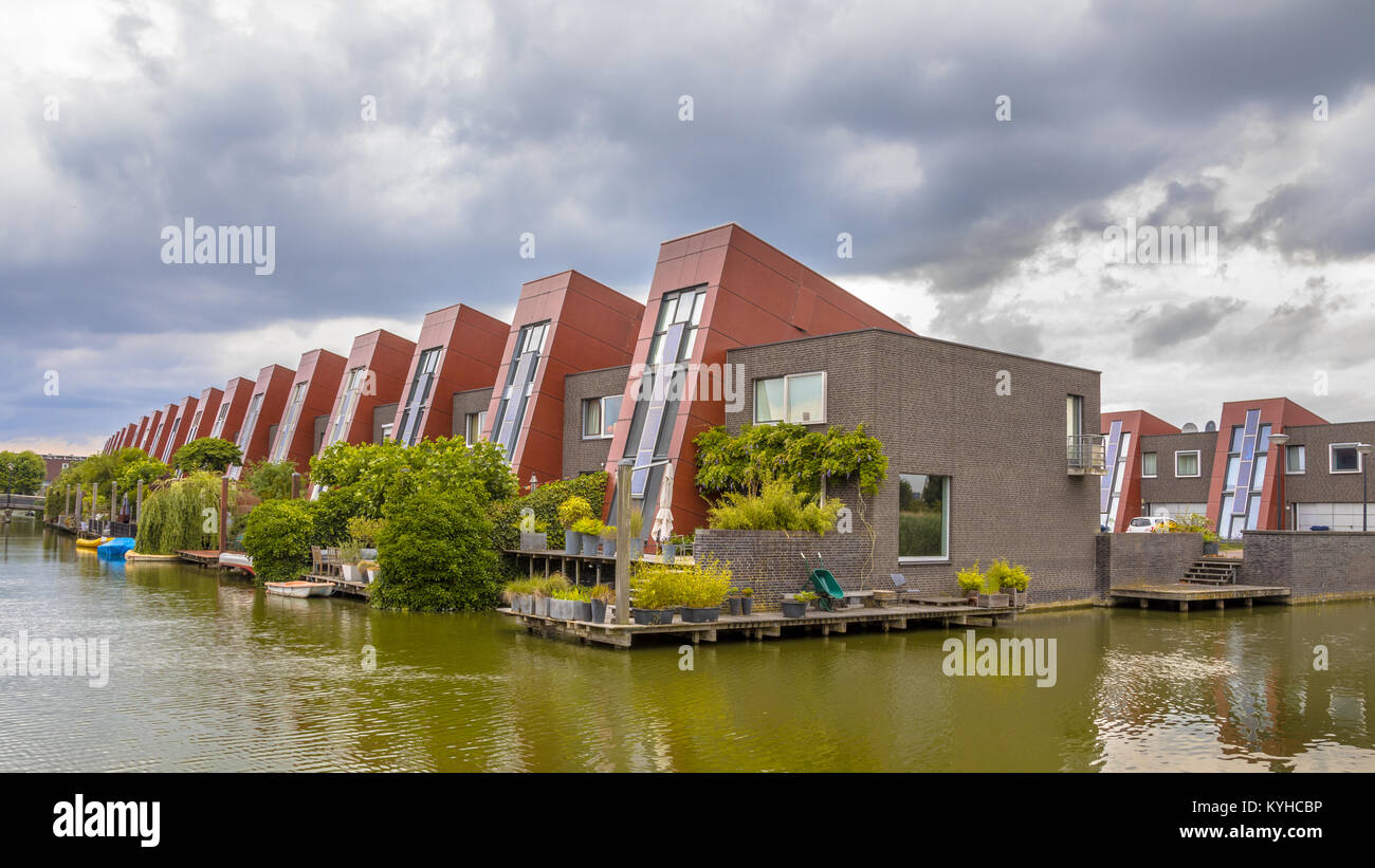 Waterfront houses with integrated solar panels and hanging gardens on waterfront in urban area of The Hague, Netherlands Stock Photo