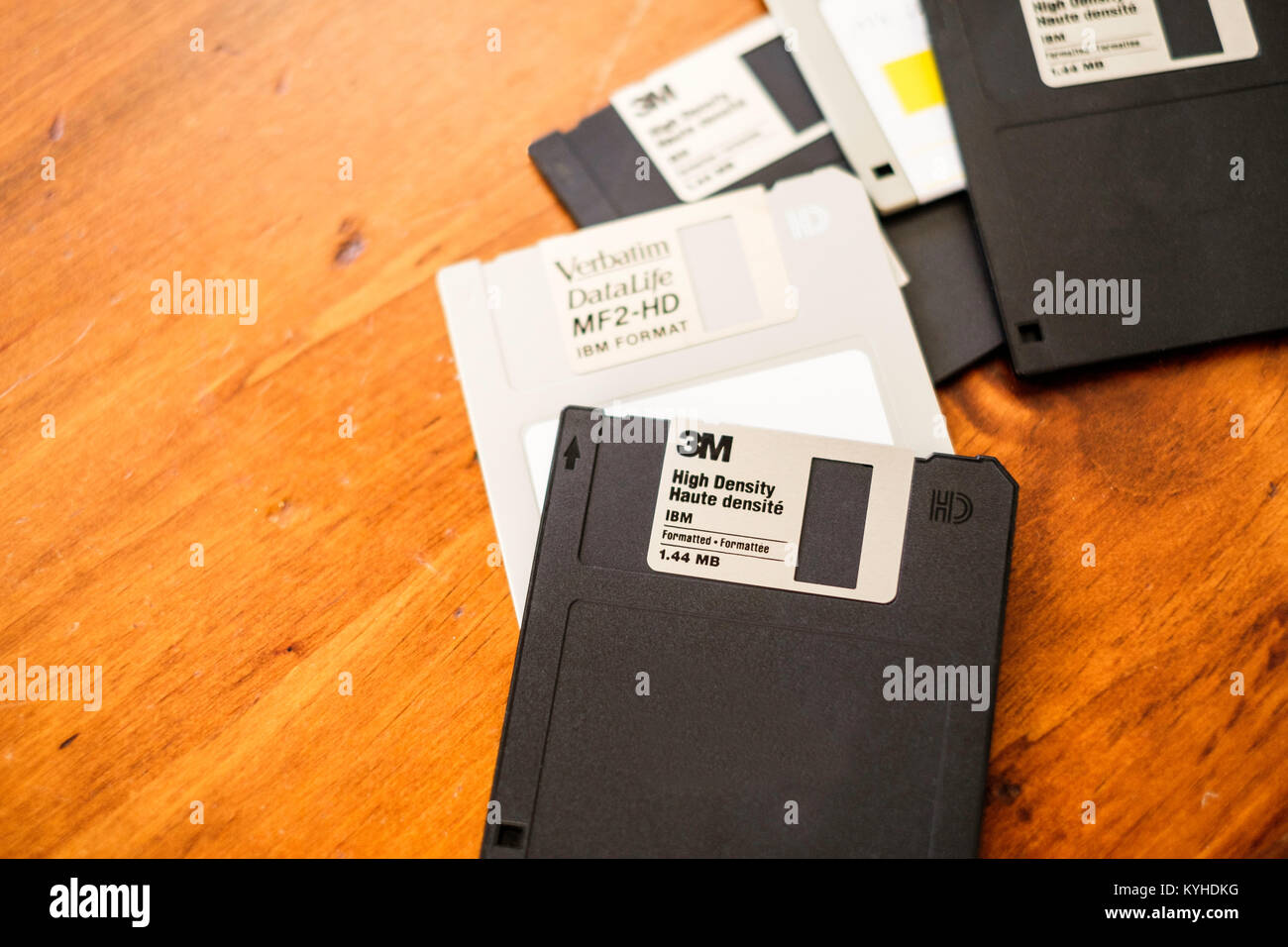 A pile of old 3M and Verbatum floppy discs on a wood table. USA. Stock Photo