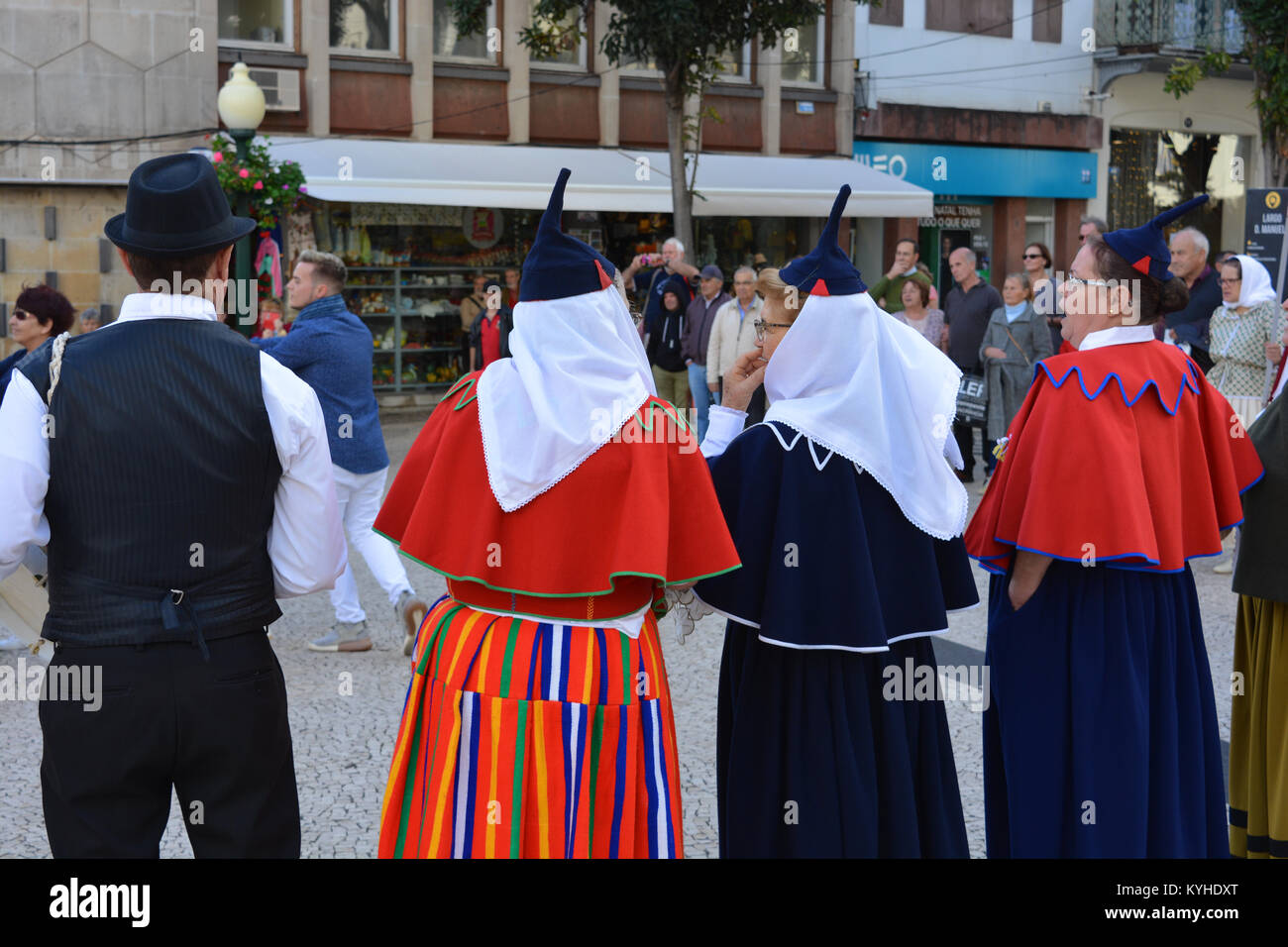 Candid view 4 folk singers with carapuca caps accompanying a group of folk dancers with spectators looking on, Funchal, Madeira, Portugal Stock Photo