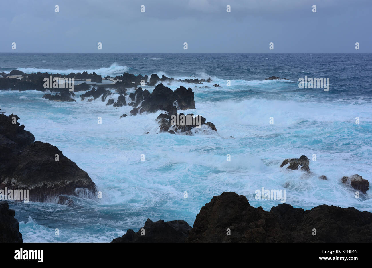 Stormy weather. Waves crashing on the volcanic lava rocks at Porto Moniz, Madeira Stock Photo