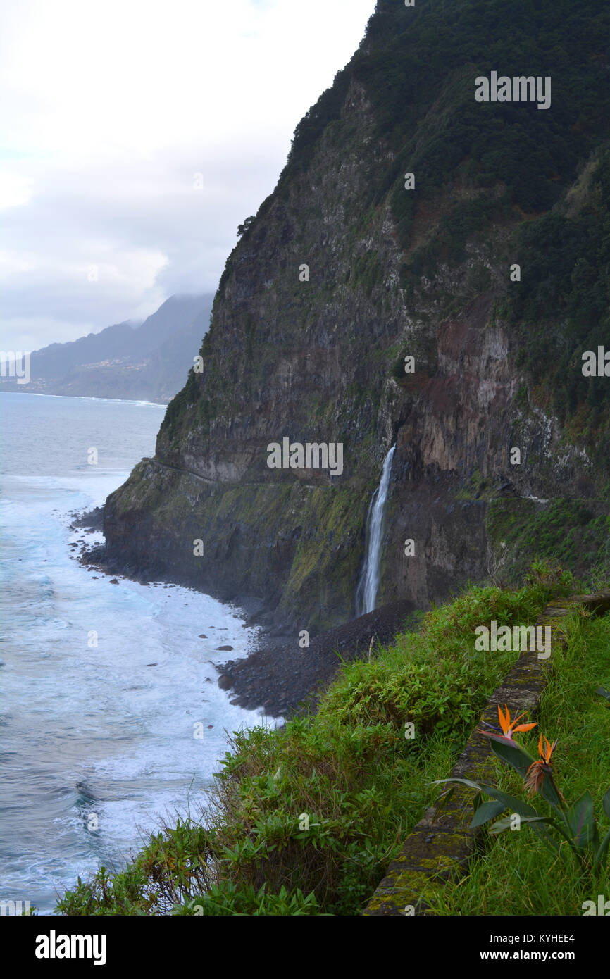 Coastal view, Bridal Veil Falls, cliff erosion, and the old coast road now closed due to the danger of mud slides & falling rocks, Madeira Portugal Stock Photo