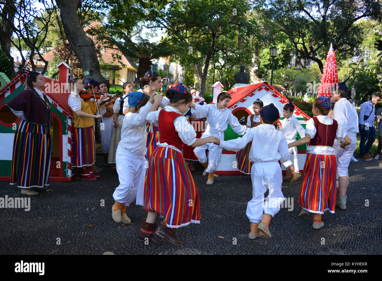 Group of young folk dancers and folk musicians  performing outdoors in the Municipal Gardens in Funchal, Madeira, at Christmas time. Stock Photo