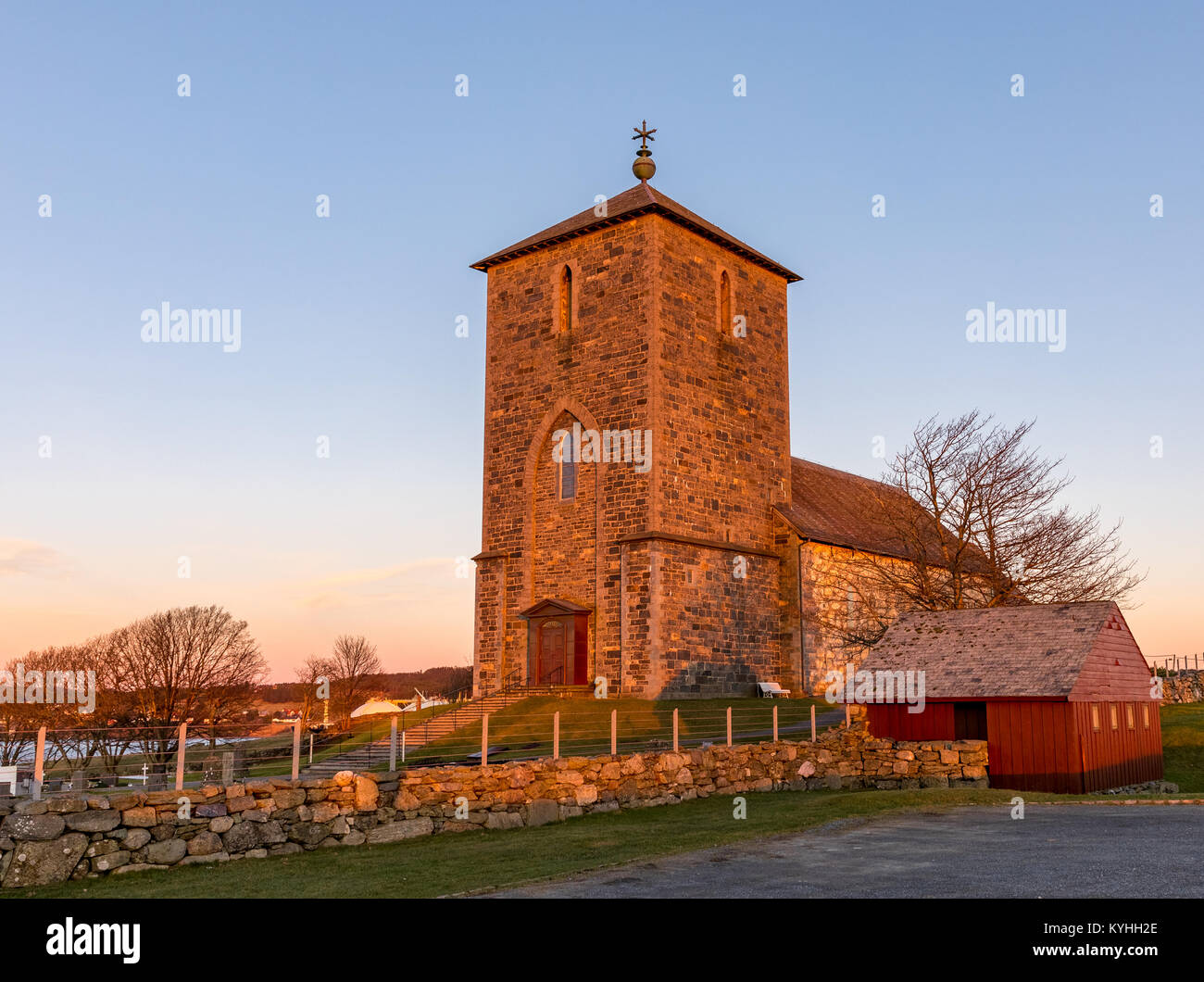 The medieval stone church at Avaldsnes, on the Island of Karmoy, Norway, vertical image of the front entrance and stairs Stock Photo