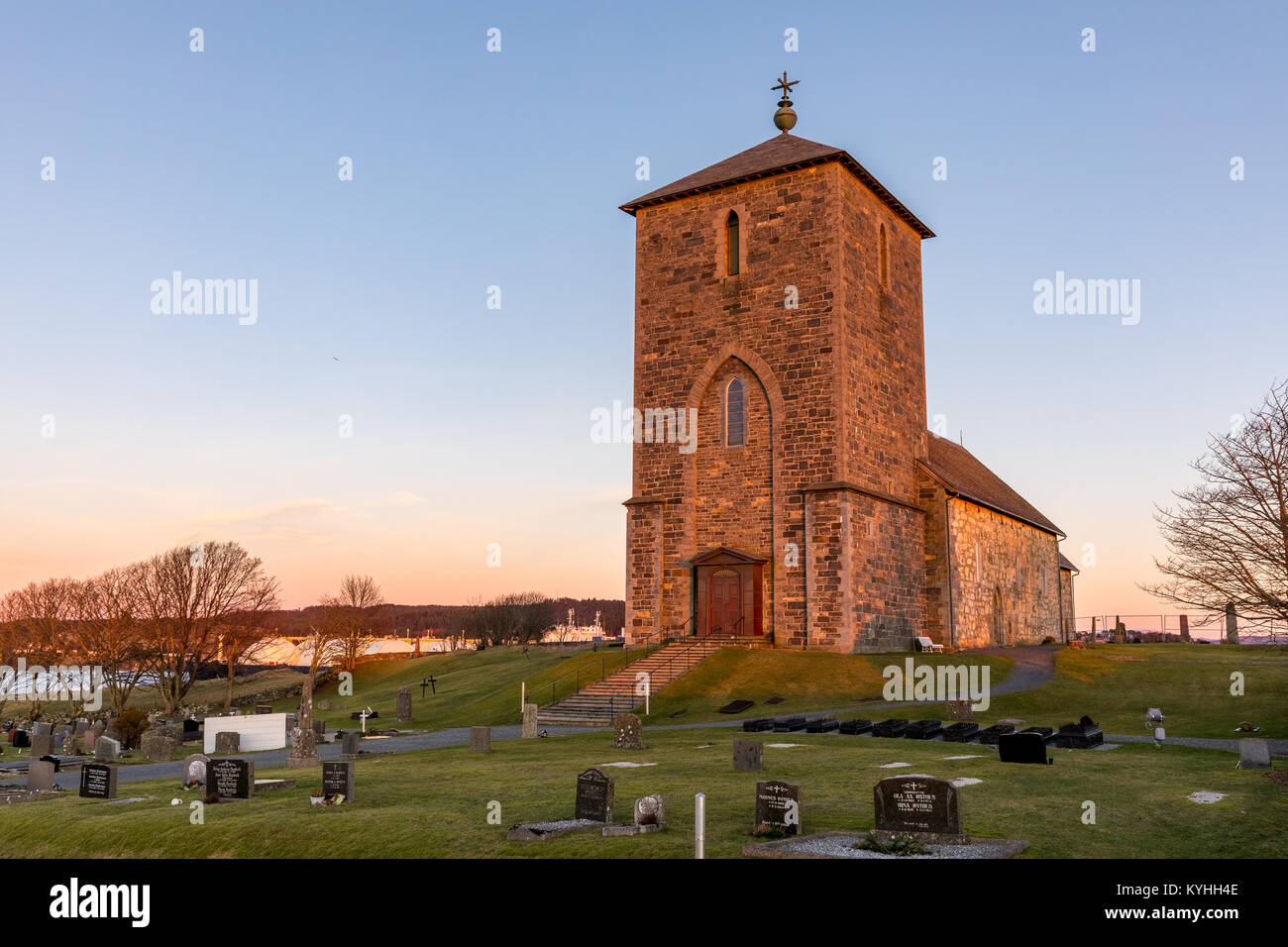 Avaldsnes in Karmoy, Norway, January 9, 2018: The medieval stone church at Avaldsnes, on the Island of Karmoy, Norway, vertical image of the front entrance and stairs Stock Photo