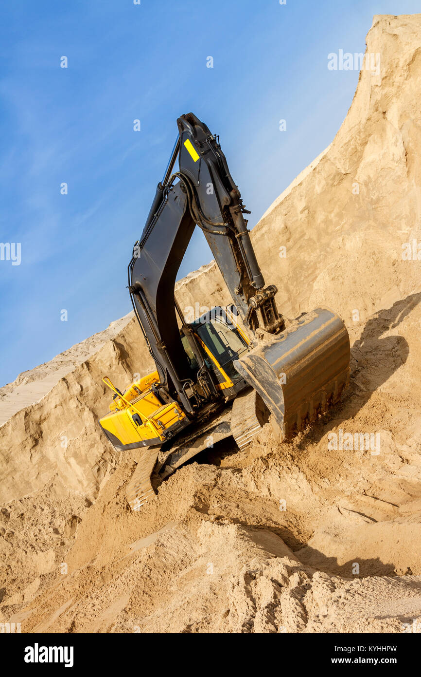 Working Yellow Excavator working at Construction Site Stock Photo - Alamy