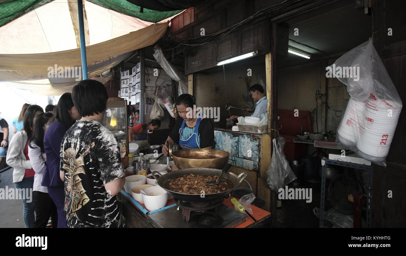 Most of common folks eat at the outside food street venders in Bangkok Thailand Stock Photo
