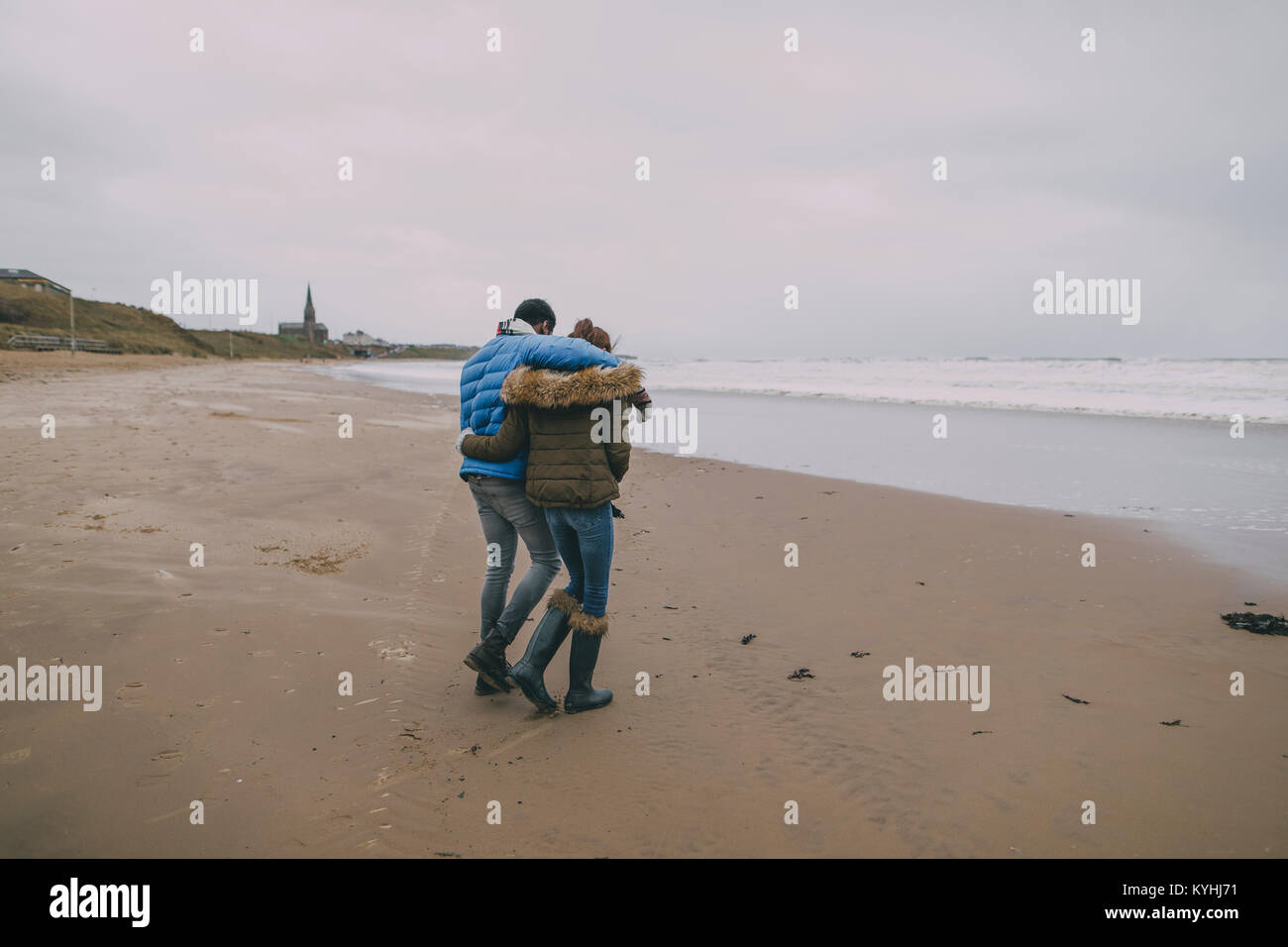 Young couple with arms around each other hi-res stock photography and ...