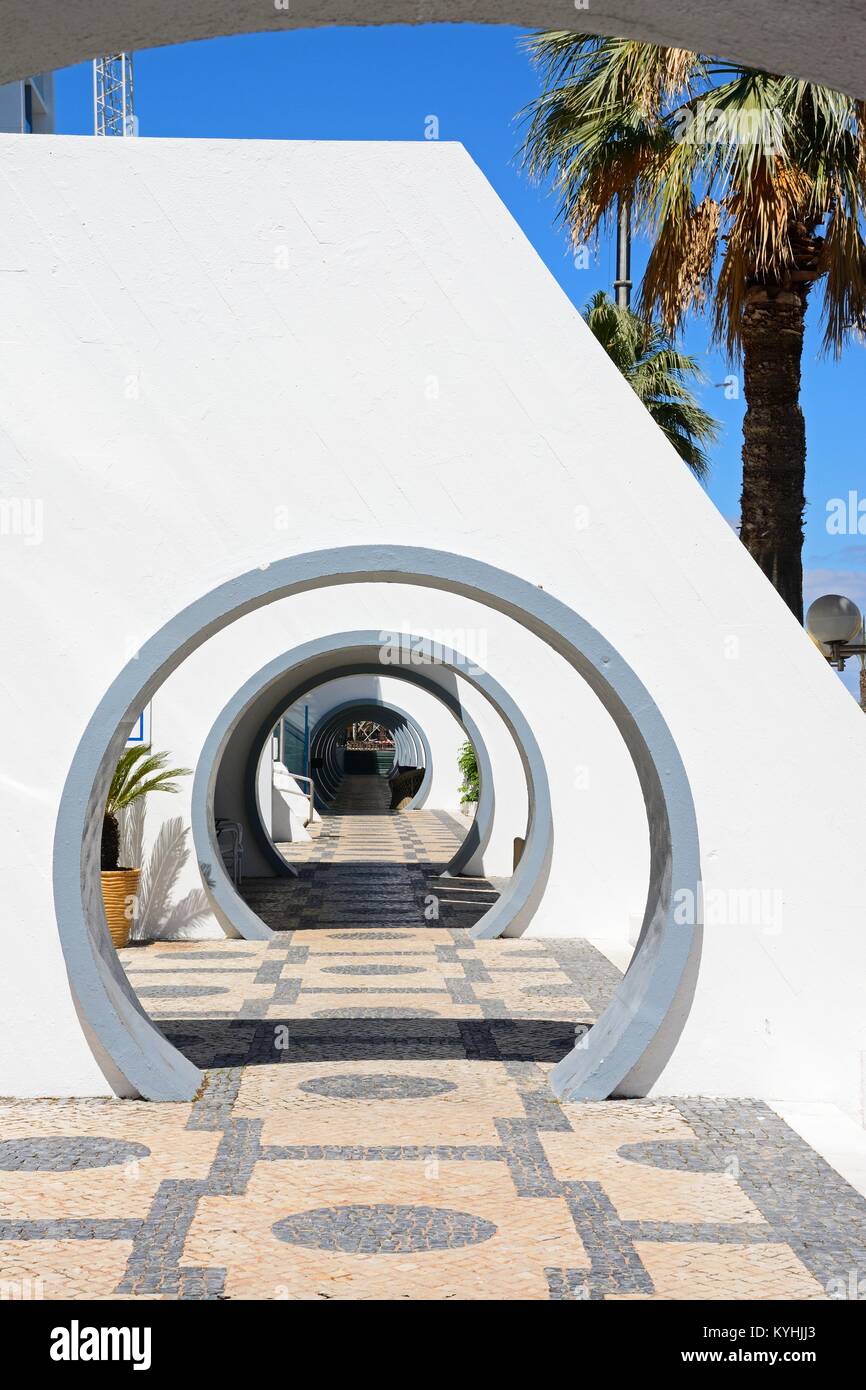 Round archways to bars and shops along the edge of the marina, Vilamoura, Algarve, Portugal, Europe. Stock Photo