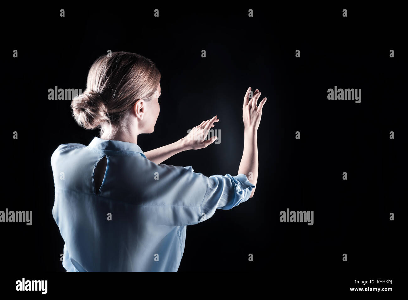 Joyful pretty woman holding her hands in front of her Stock Photo - Alamy