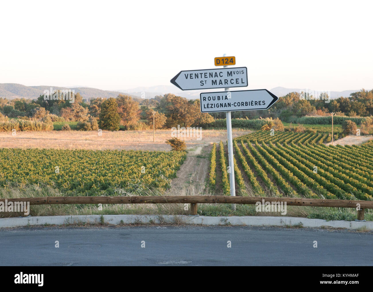 French road sign on country lane with views of vine yards behind with early evening light and reaching views of the hills Stock Photo