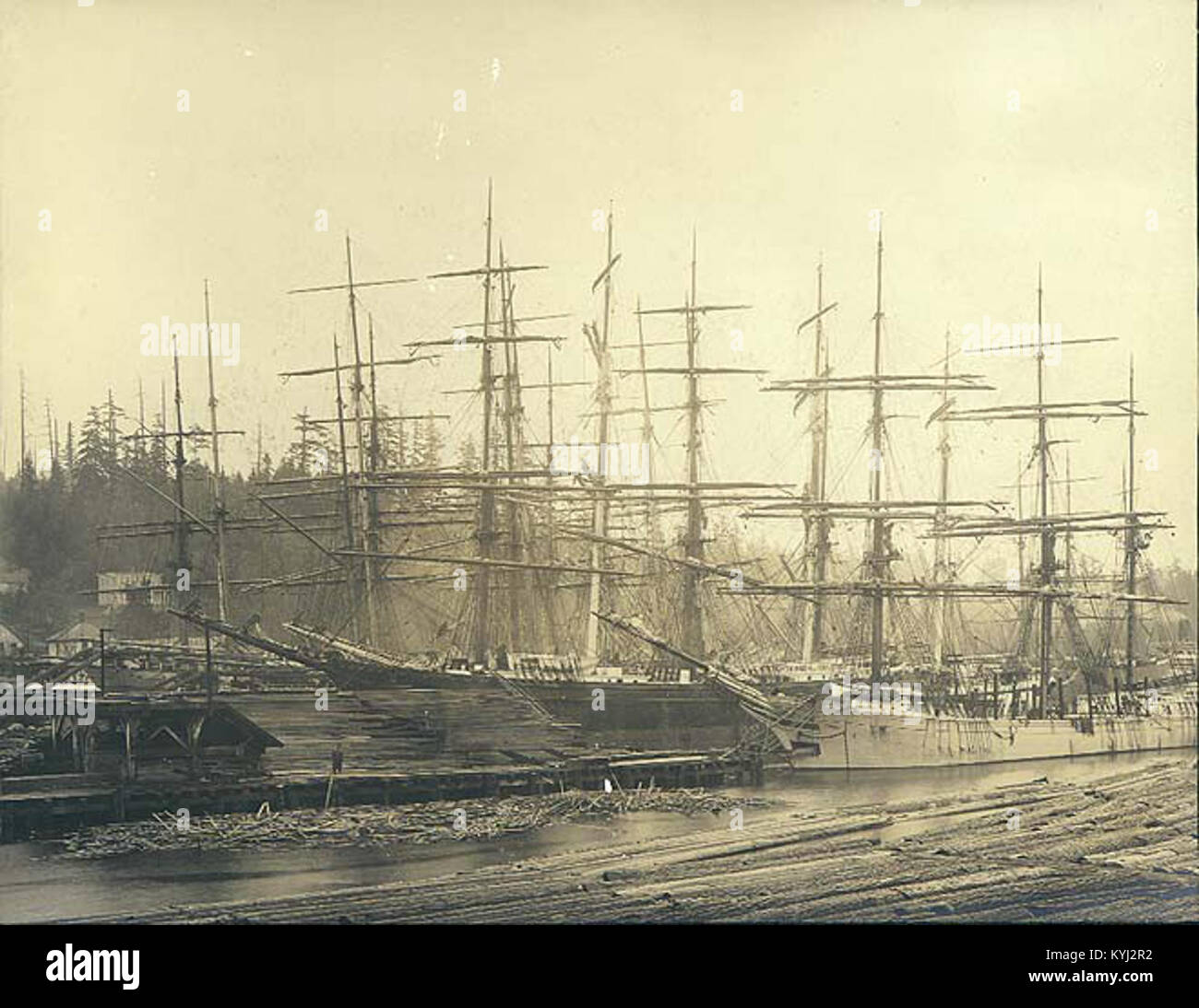 Ships loading lumber at dock, Port Blakely lumber mill, Washington, ca
