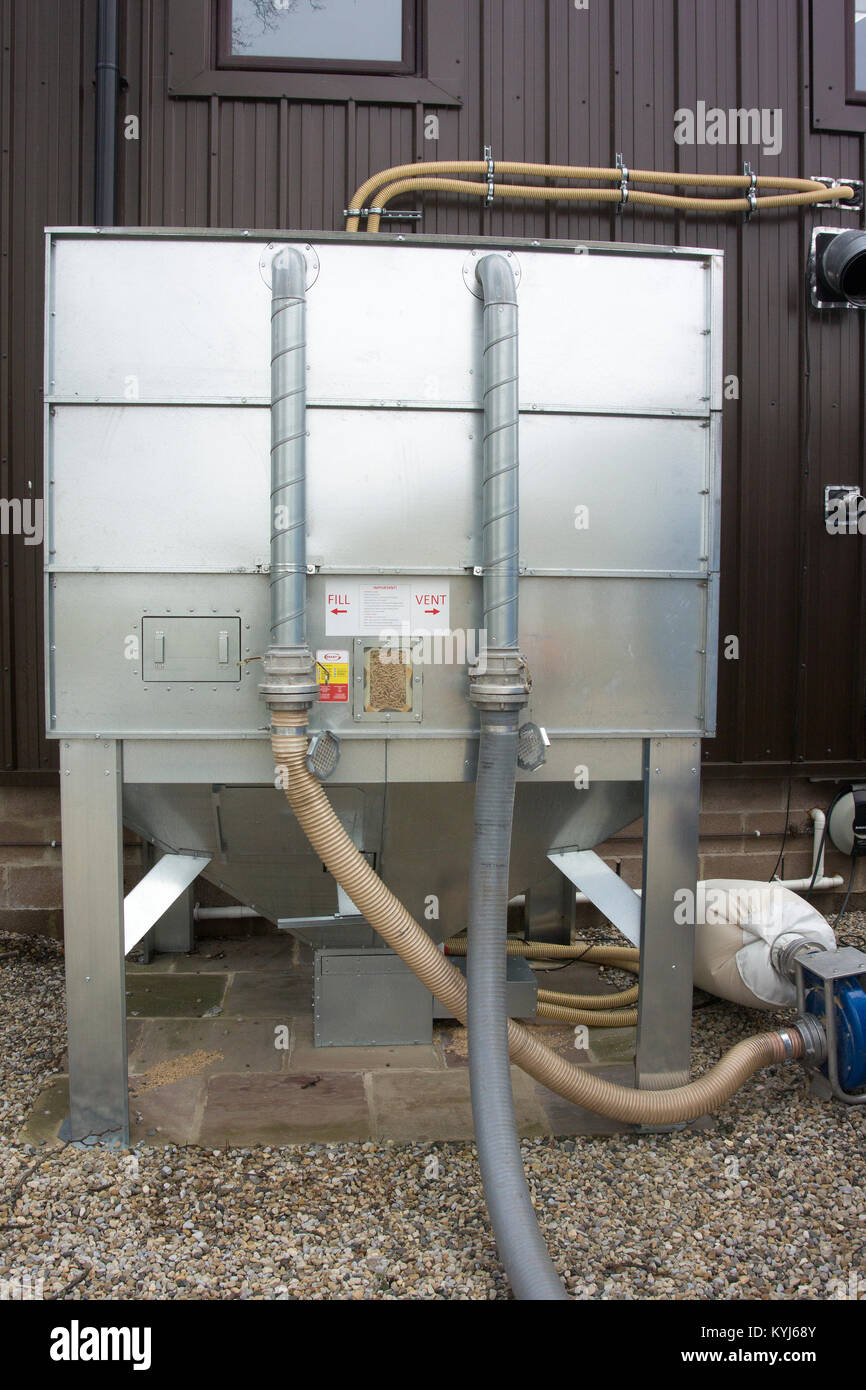 Wood pellets being delivered into a bulk hopper for use in Bio Fuel heater at an industrial park, UK. Stock Photo